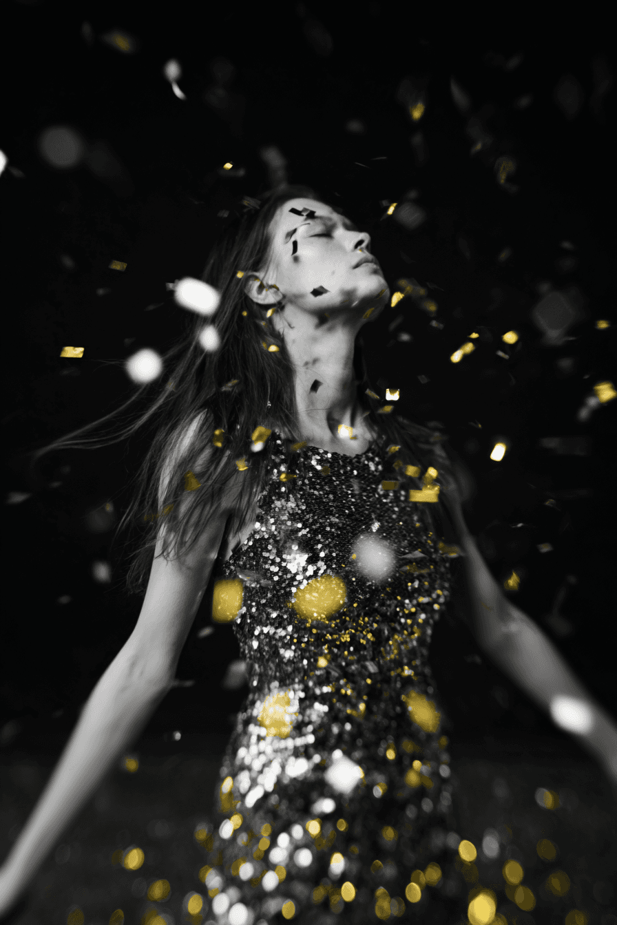 Woman in sequin dress dancing with head back, golden confetti falling around her