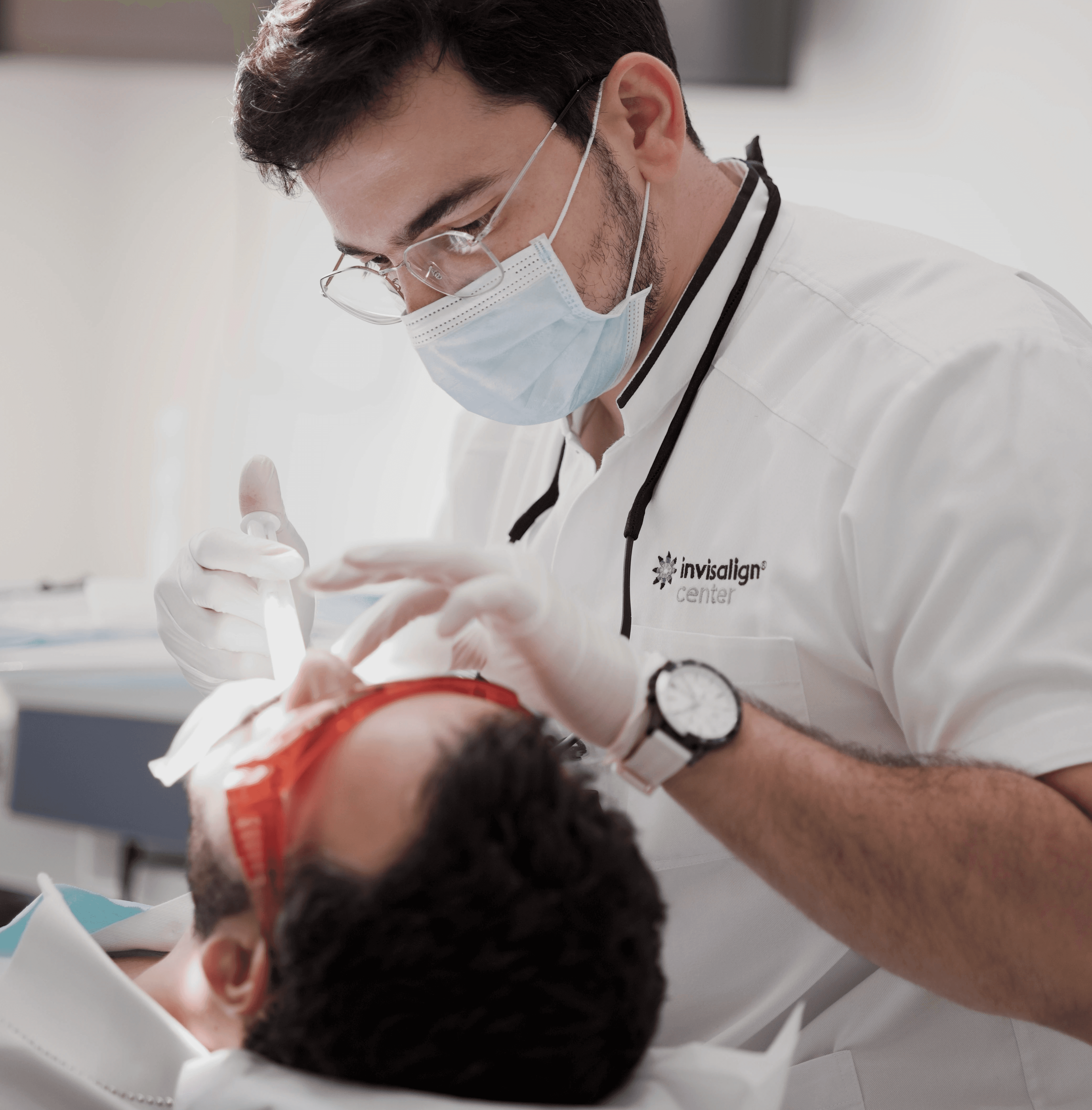 An Invisalign Center expert dentist performing a composite veneer installation to a patient 