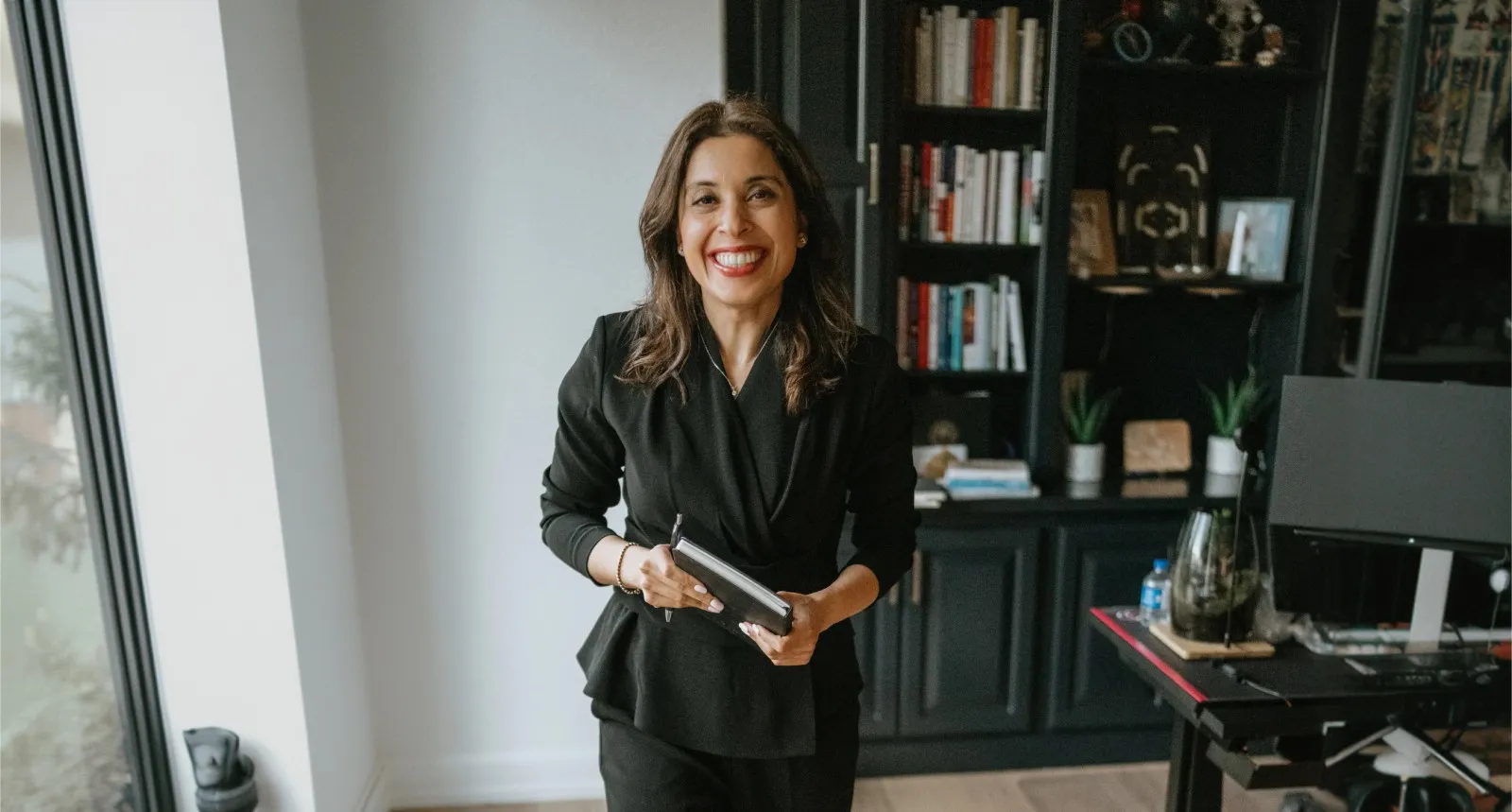 Dr. Maryam Sheikh smiling in her home office