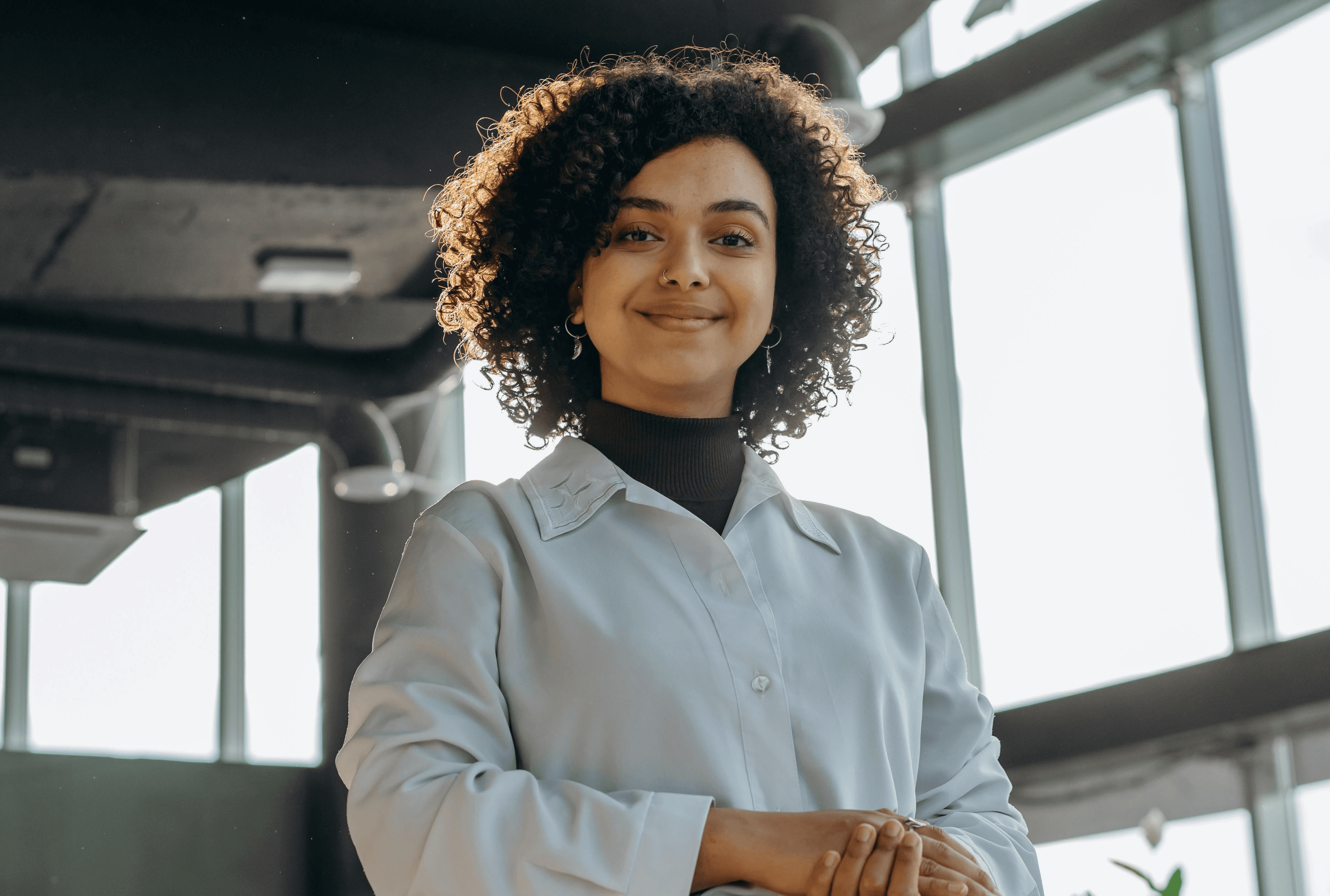 Woman wearing glasses thinking at desk
