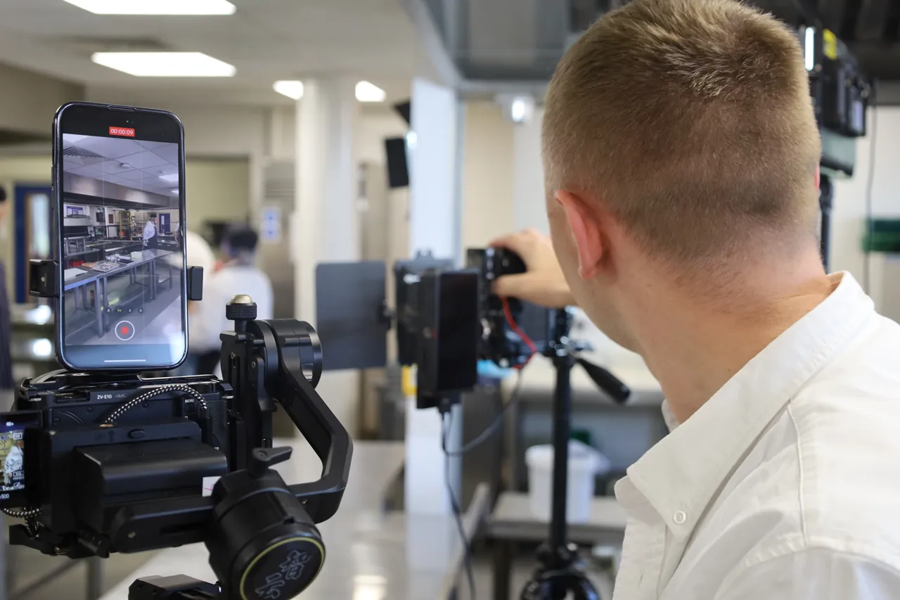 Behind the scenes filming of chef training in a professional kitchen as part of a hospitality video production project.