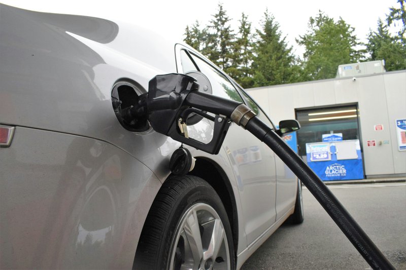an%20electric%20car%20being%20charged%20at%20a%20gas%20station