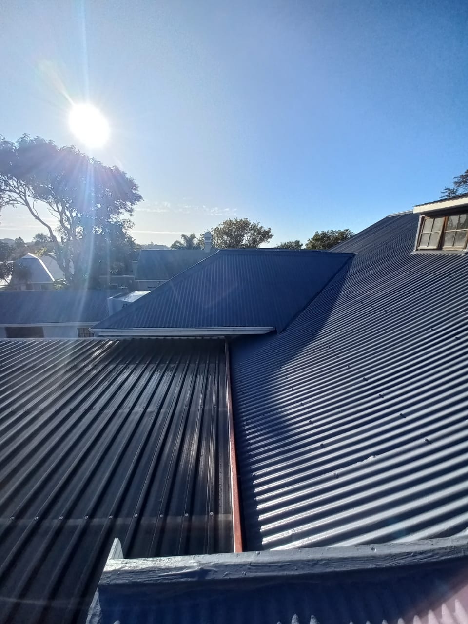 House roof getting sprayed with waterproofiing rubber