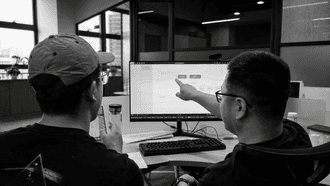 Hardware development team reviewing technical direction and early product risks