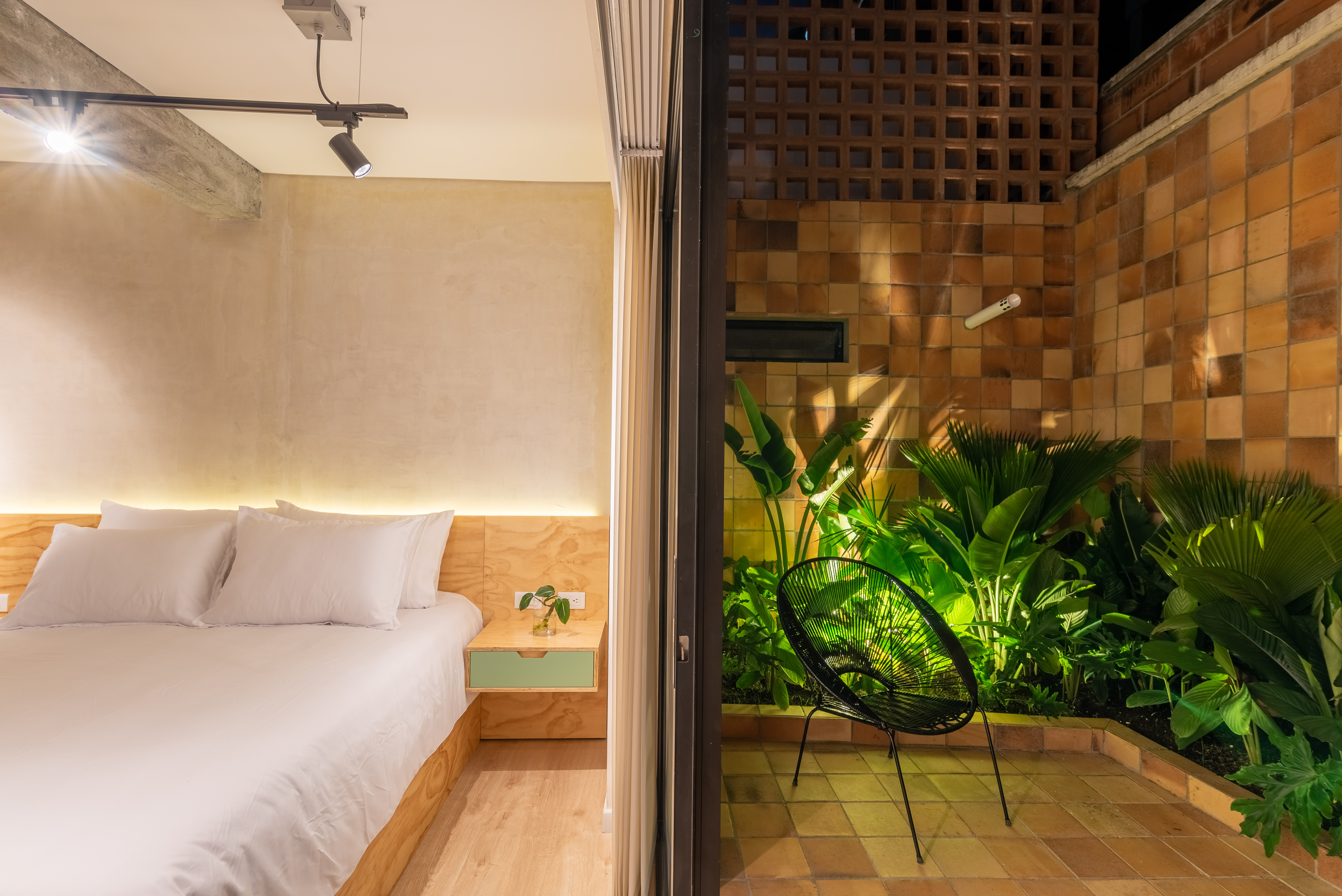 Double-height interior with flowing sculptural forms and warm raking light