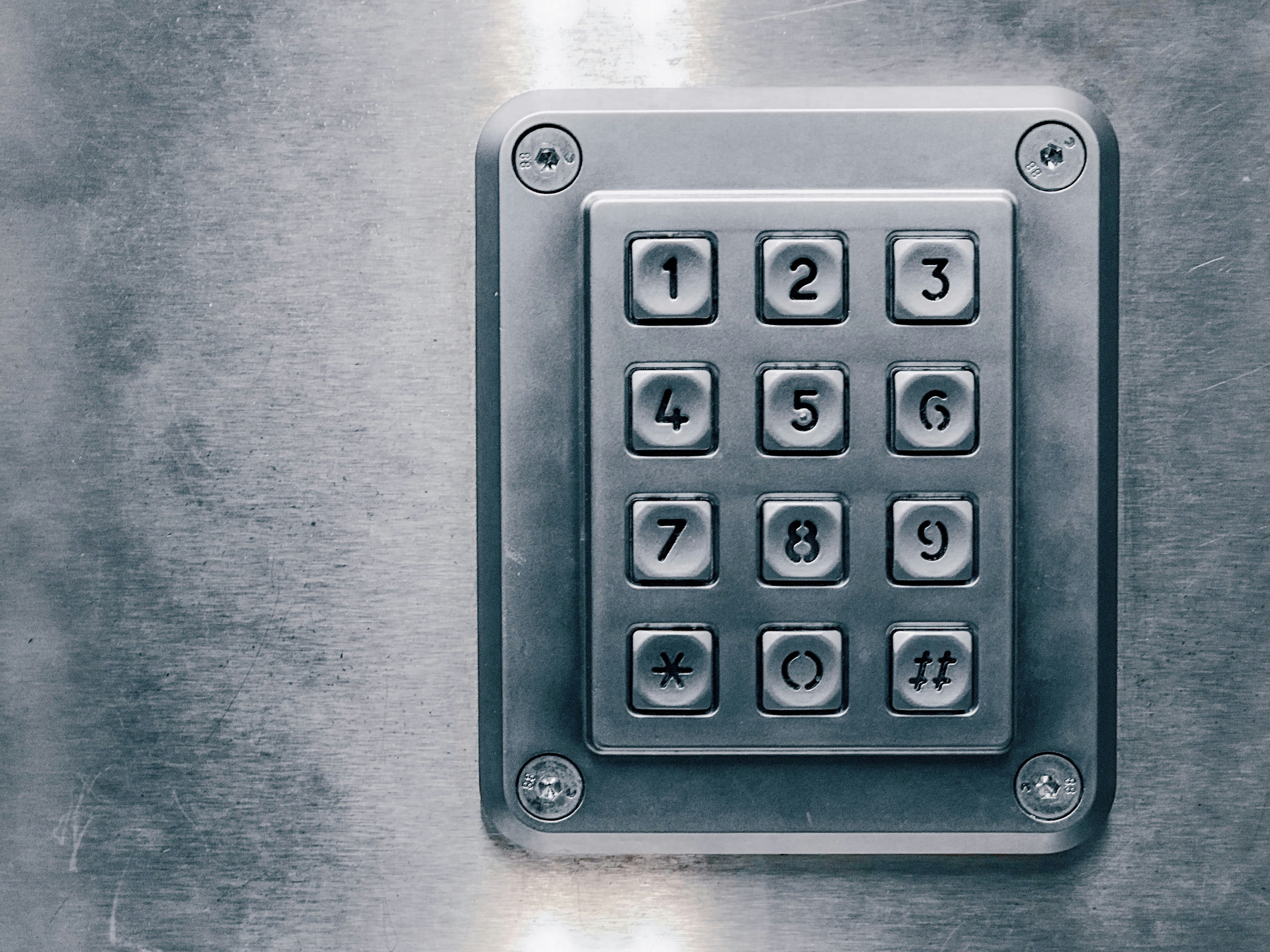 Security keypad on a metal wall, used for code-based access to a storage facility.