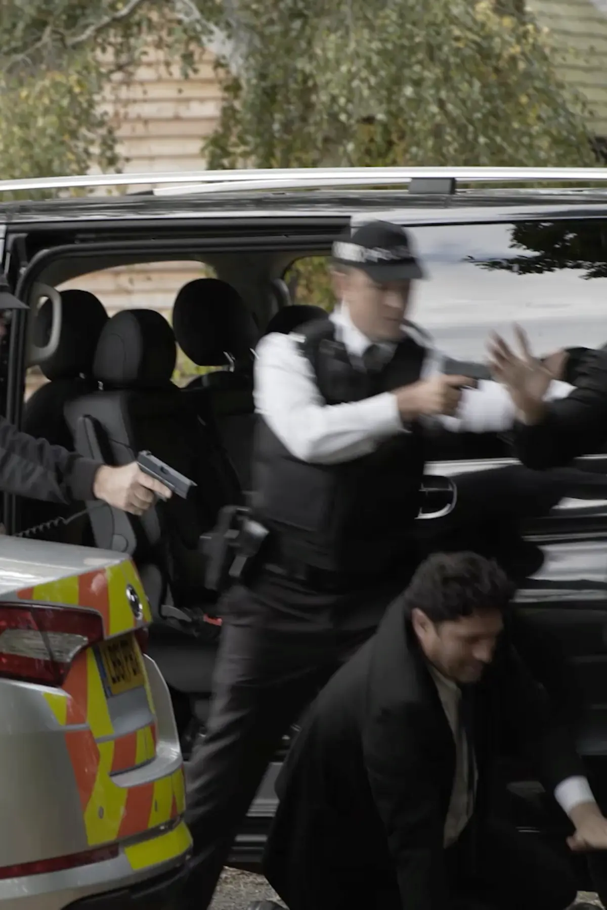 London police officers pointing firearms during a tense moment captured in the documentary filming