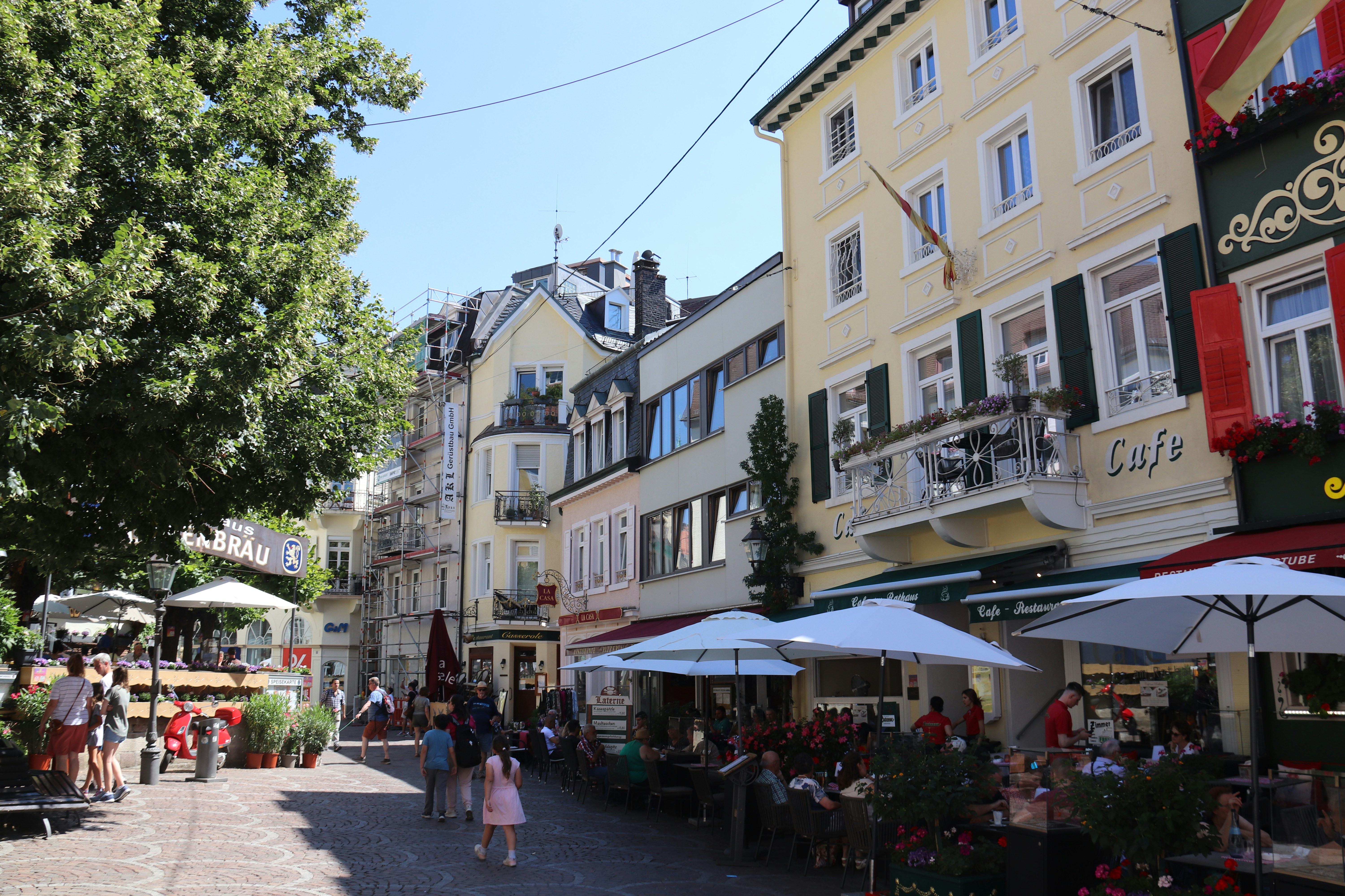 a group of people walking around a town
