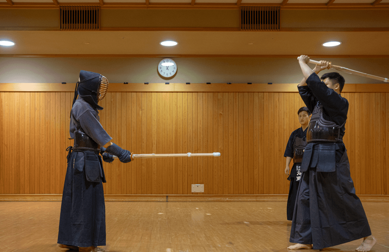 Kendo martial artists teaching a student