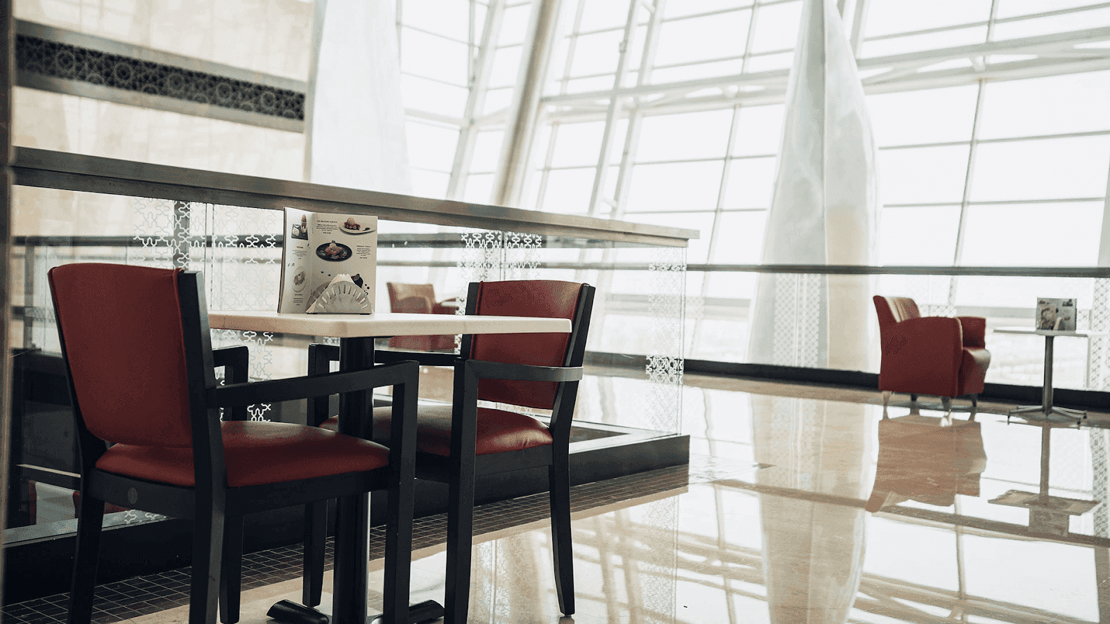 Café and comfortable seating area with large windows in the popular Nation Towers Mall dining space.