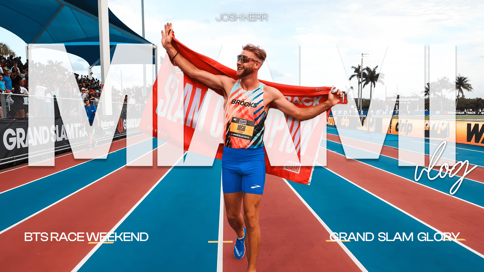 Model holding a piece of wheat in a field, gazing downward.