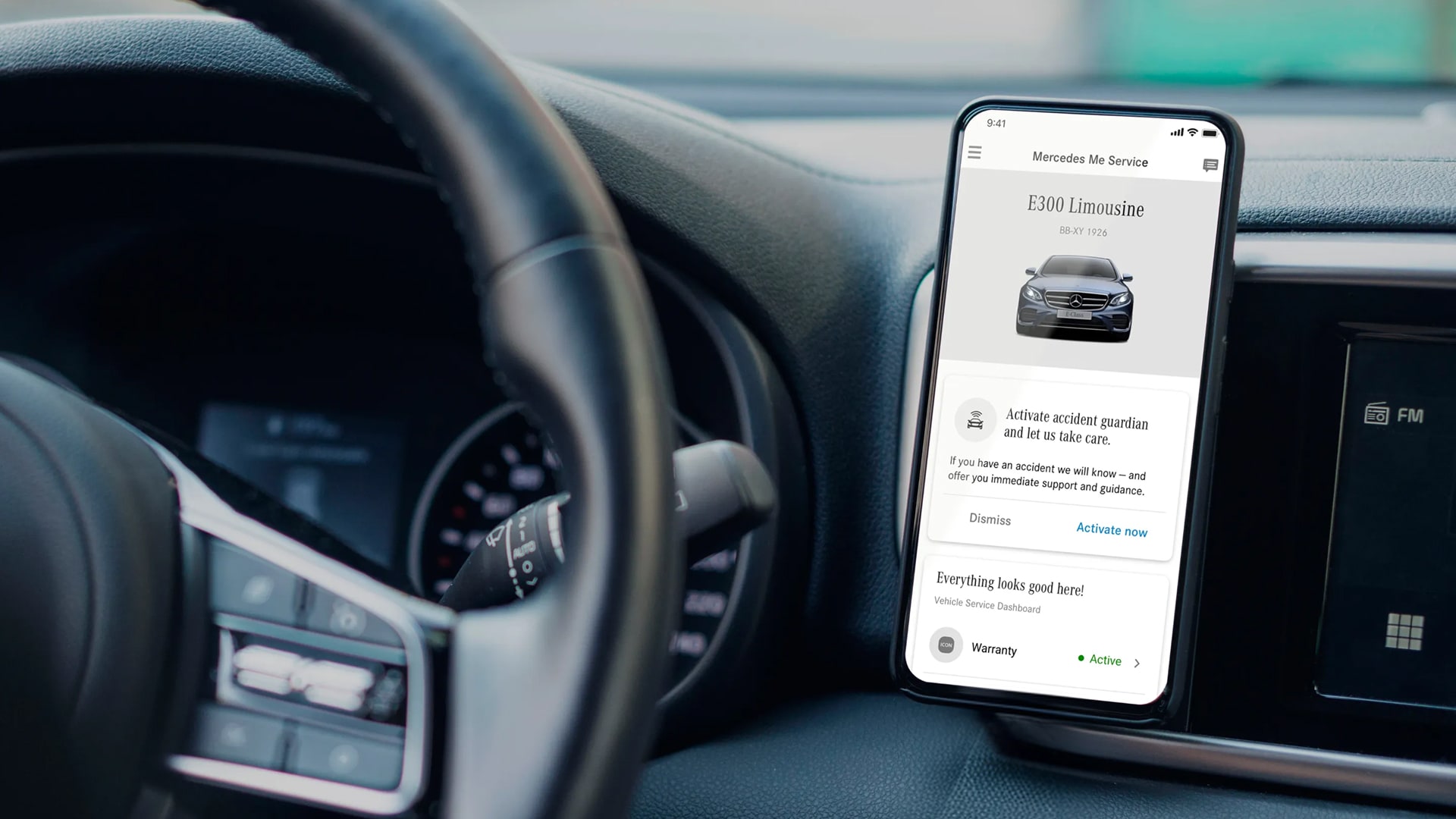 Mercedes app mounted in car showing accident guardian activation and vehicle dashboard