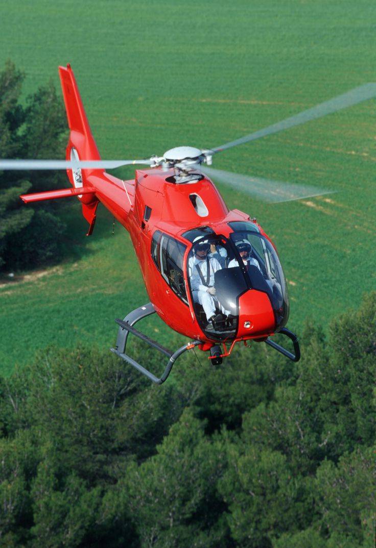 A small white airplane parked on tarmac.