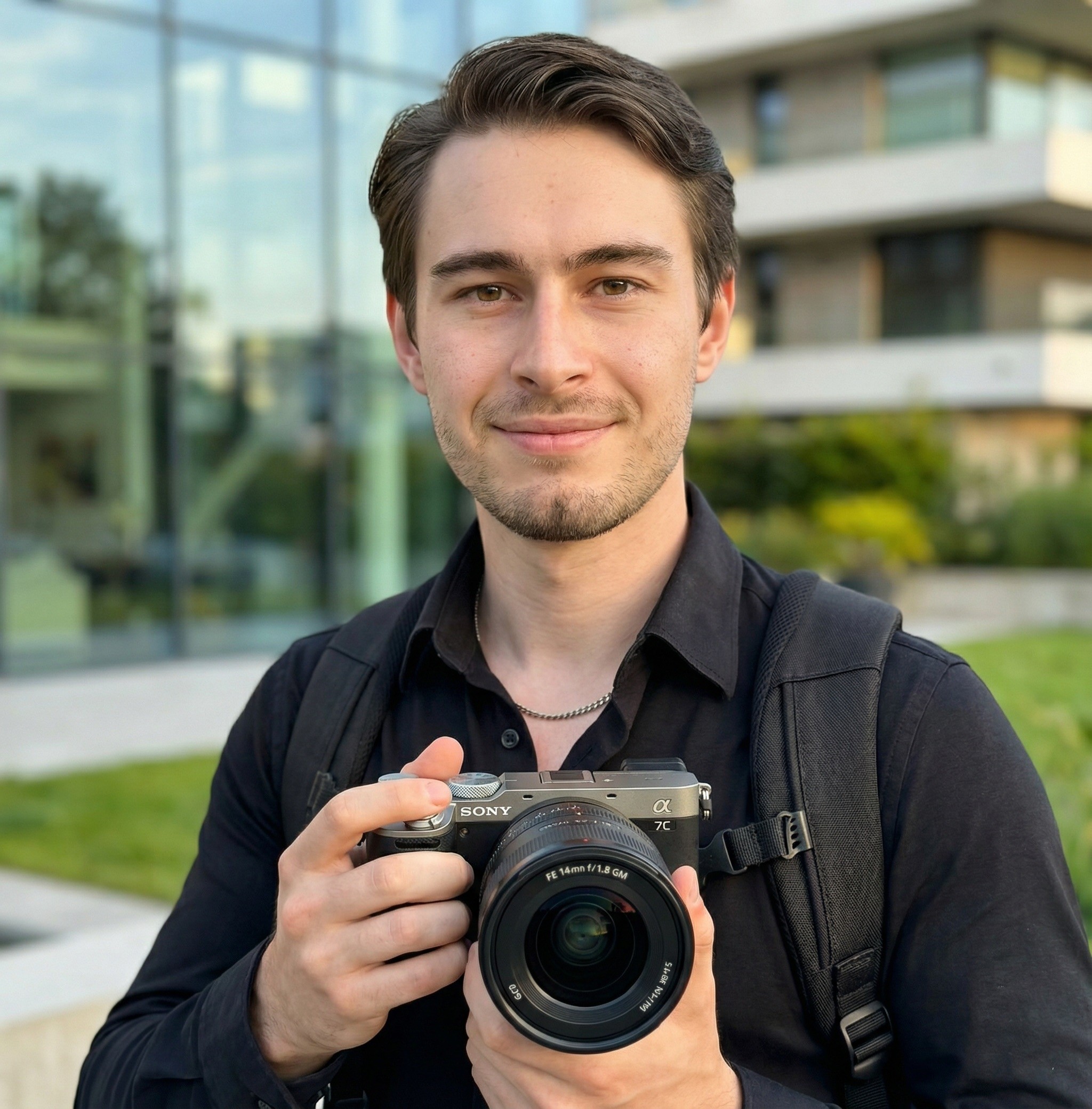 A man wearing a black cap taking a photo with a Canon camera in an urban area with bokeh effects.