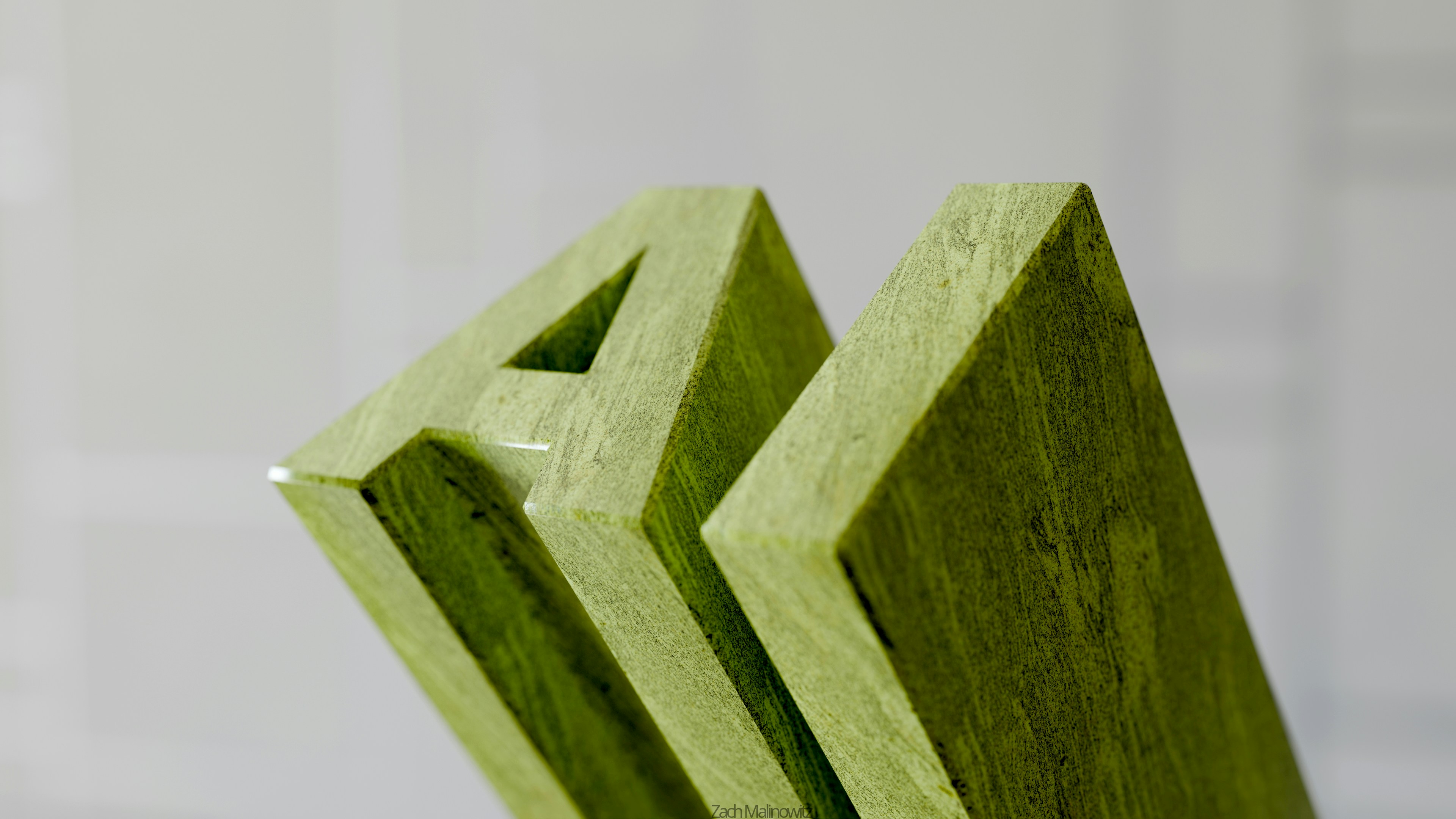 Green wooden letters spelling out "am"