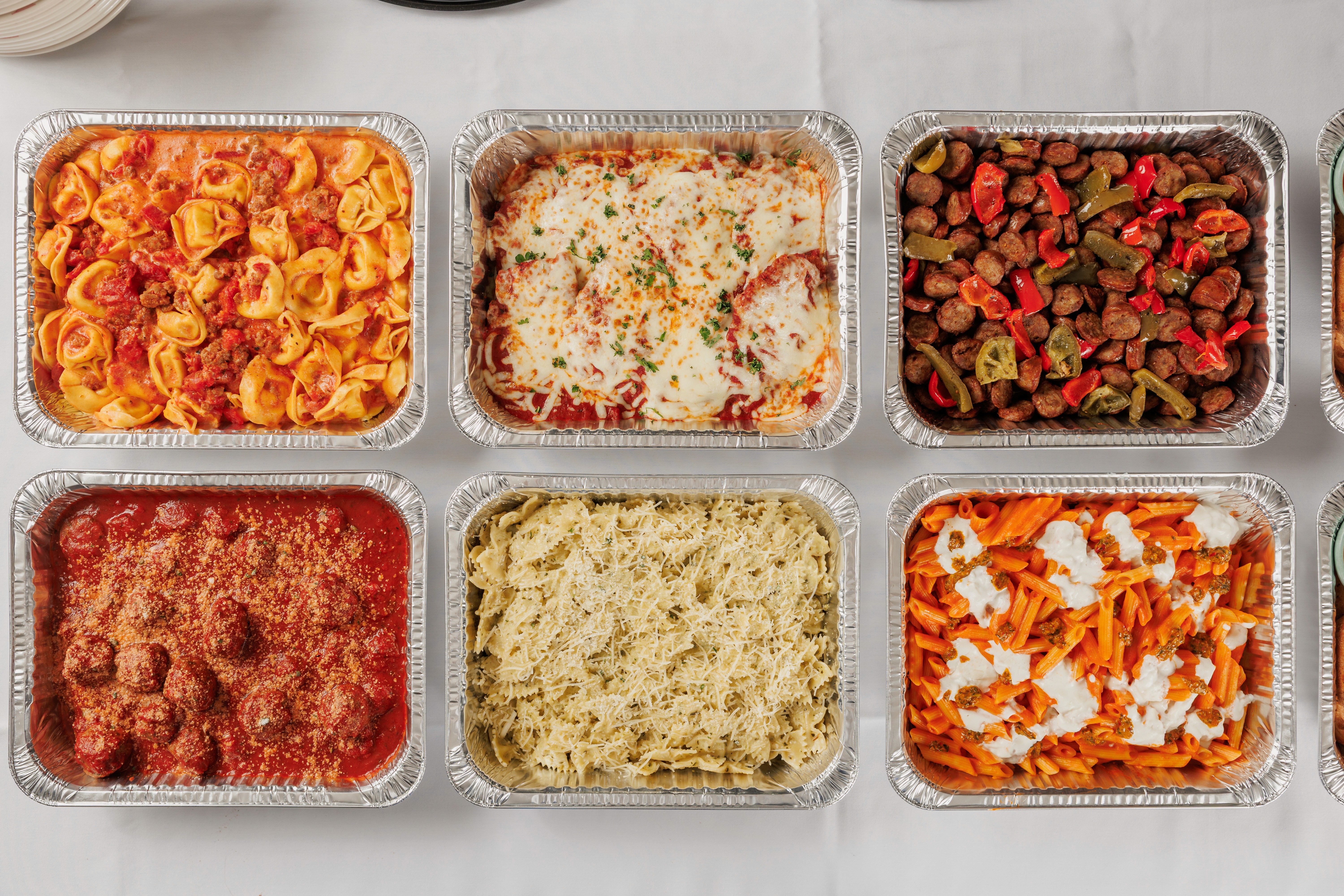 Chef plating a fried chicken sandwich