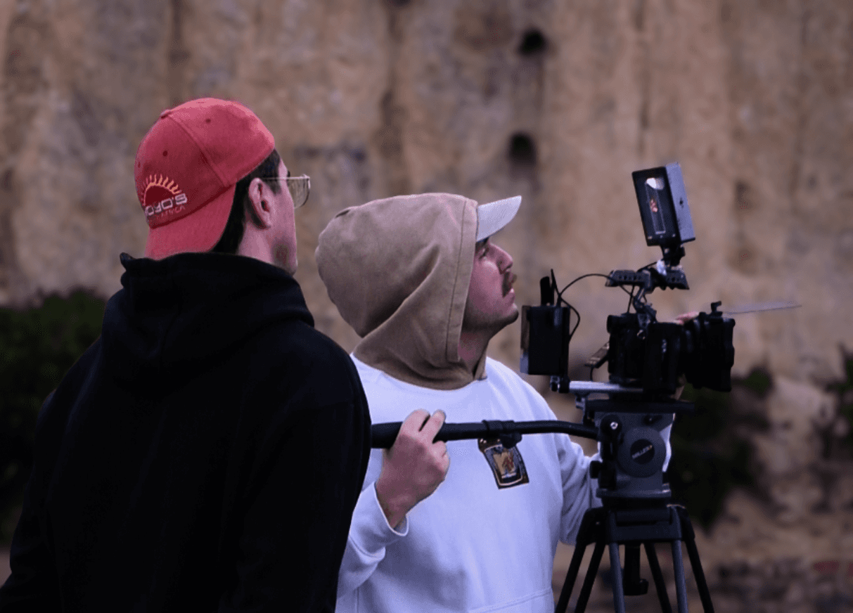 silhouette photography of man holding camera