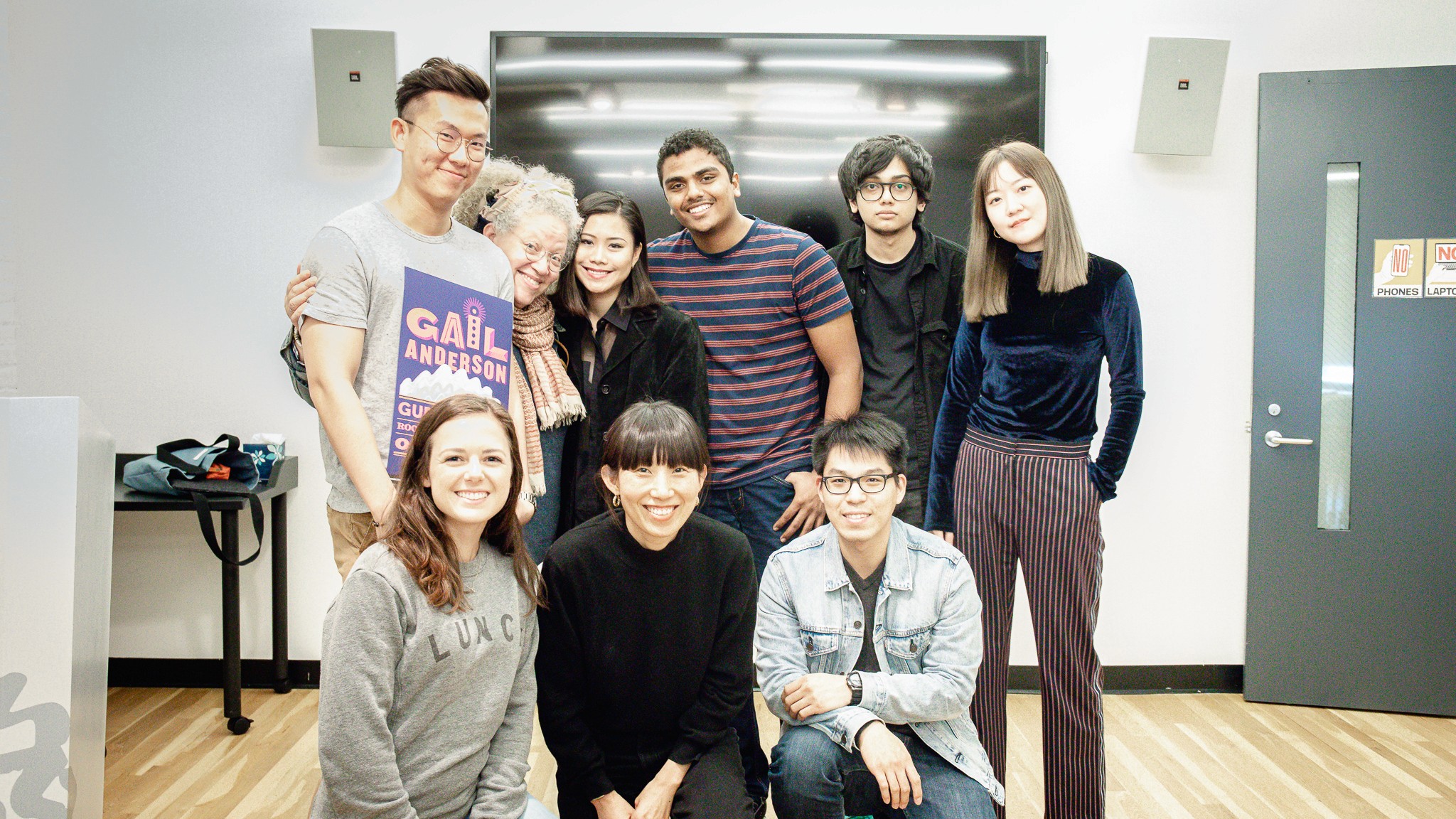 students pose with Gail Anderson