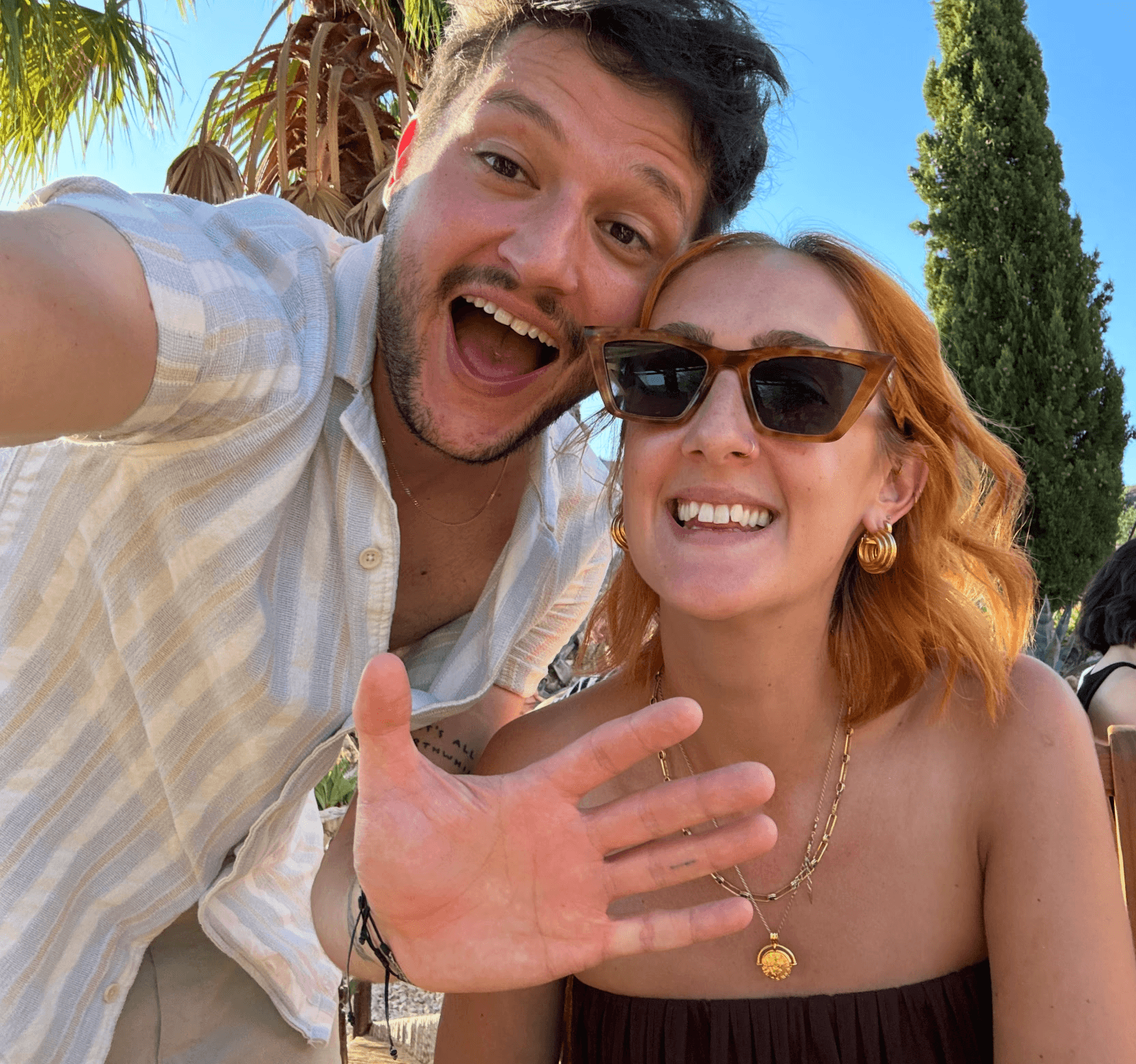 Couple portrait with dog on field