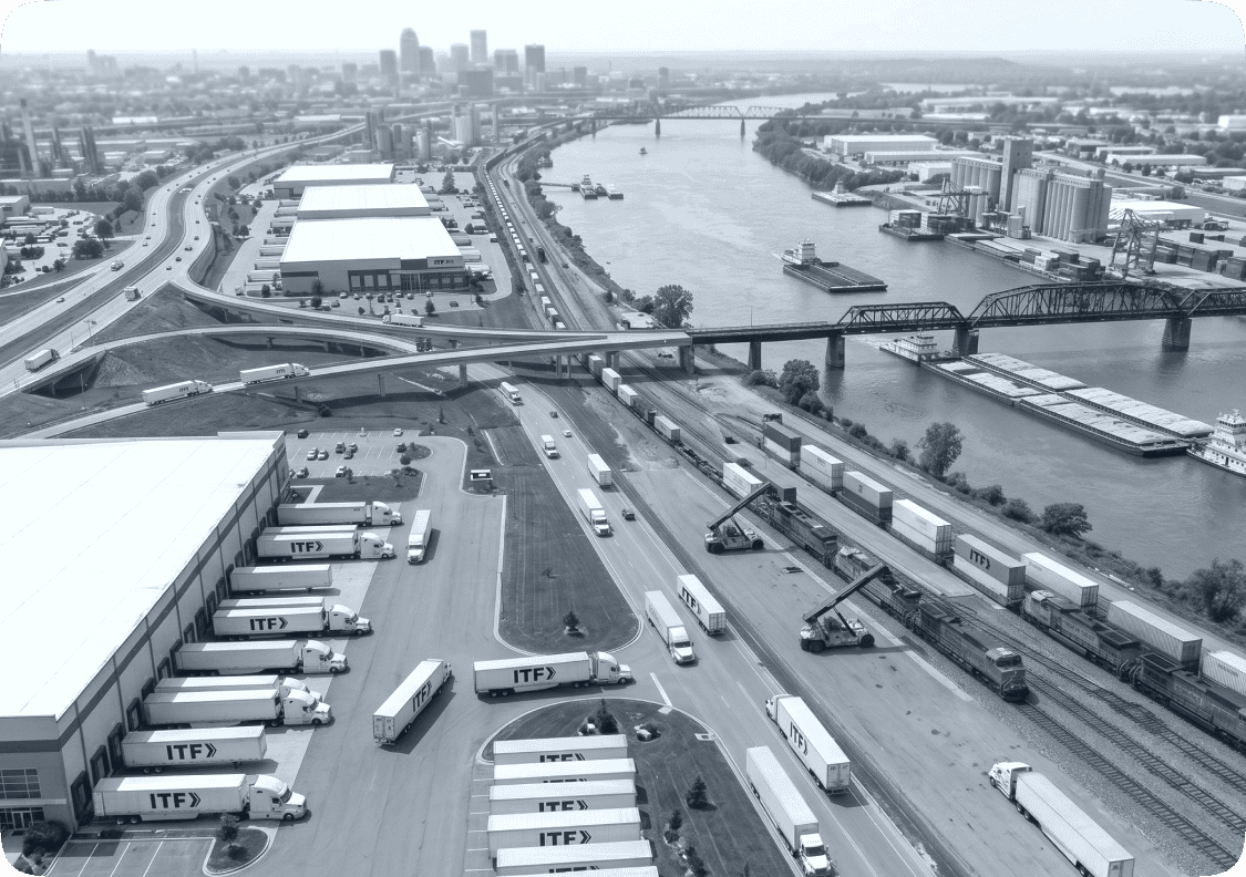 Semi‑truck passing passenger car on highway near warehouses representing trucking safety and traffic risk