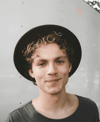 man standing near white wall