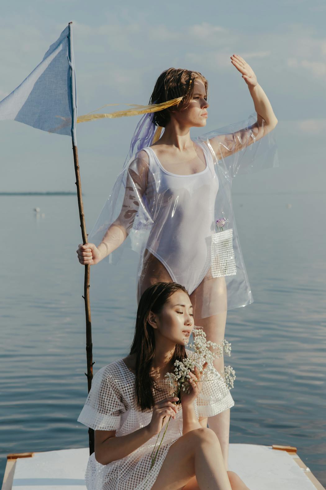Women on a wooden platform looking at the horizon