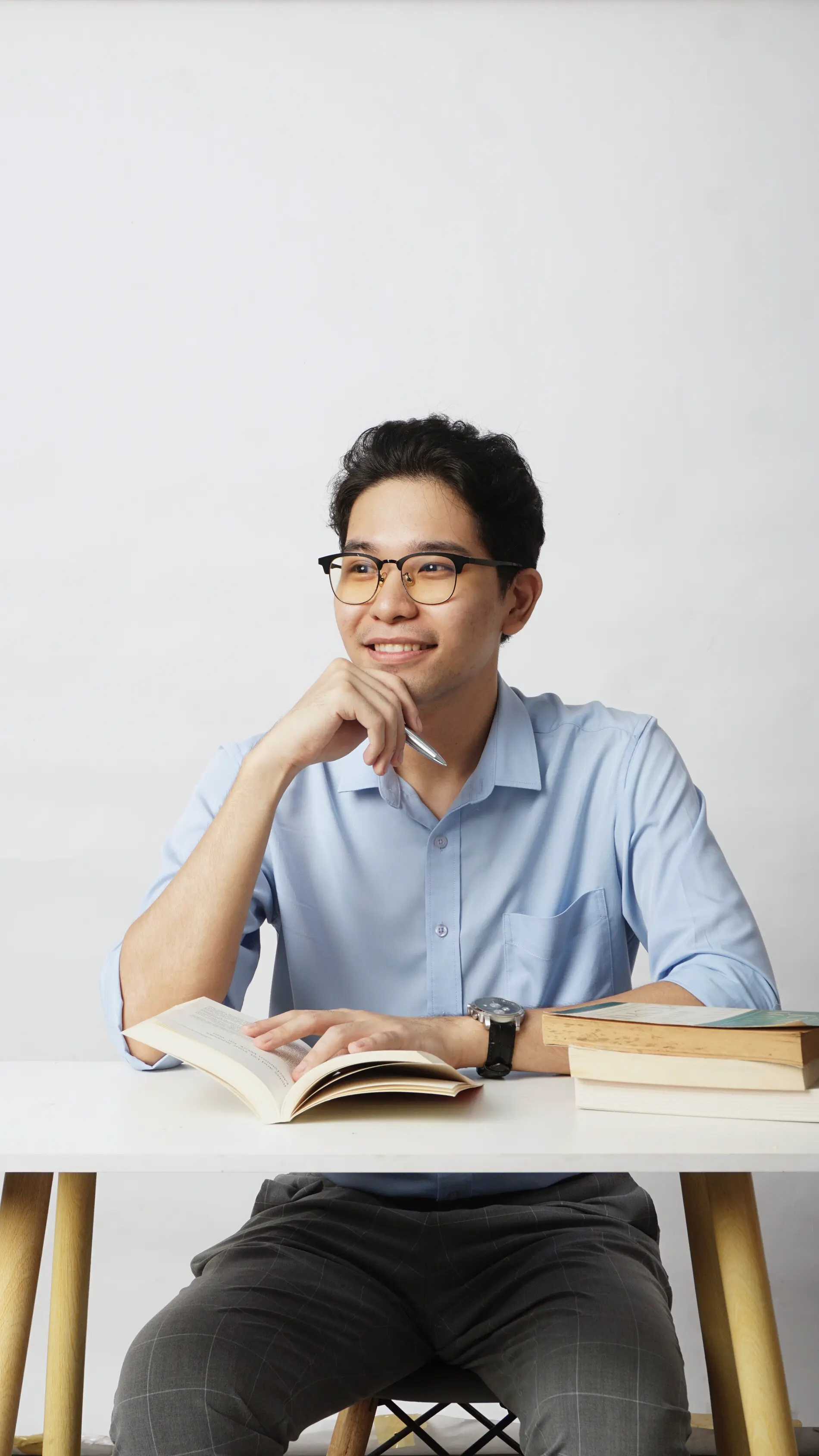 Picture of Don Ignacio smiling across the room with a book on the table