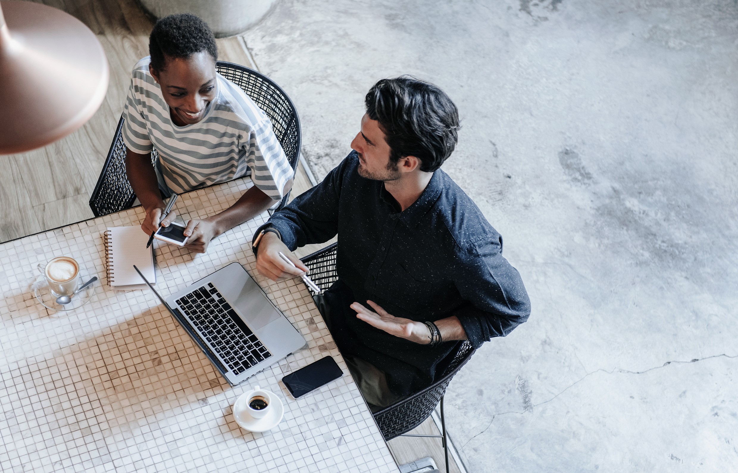 Colleagues discussing their work laptop