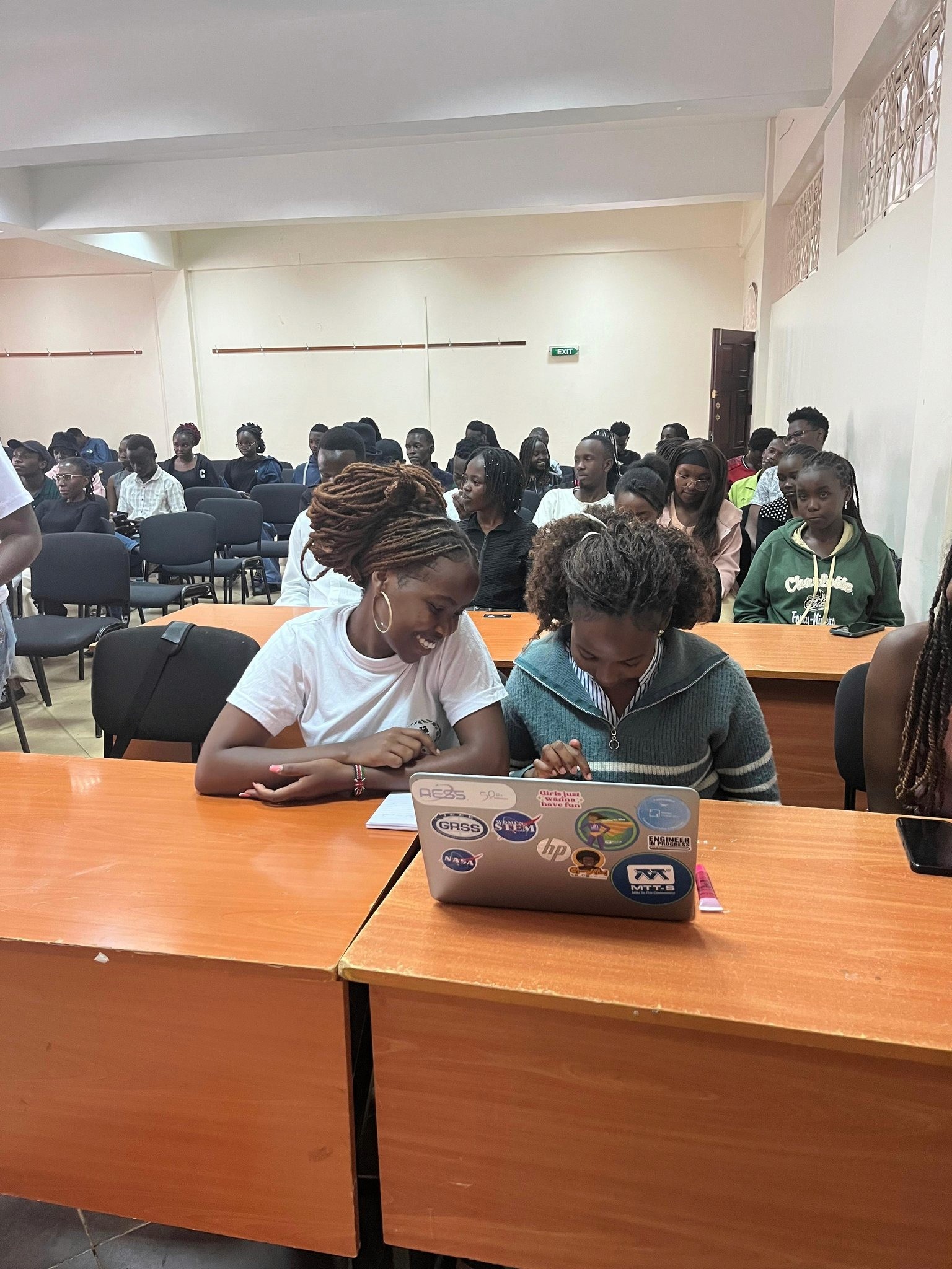 Two Kenyatta University students practise using the Fedi app during the Bitcoin onboarding session at the Bitcoin Campus Caravan event