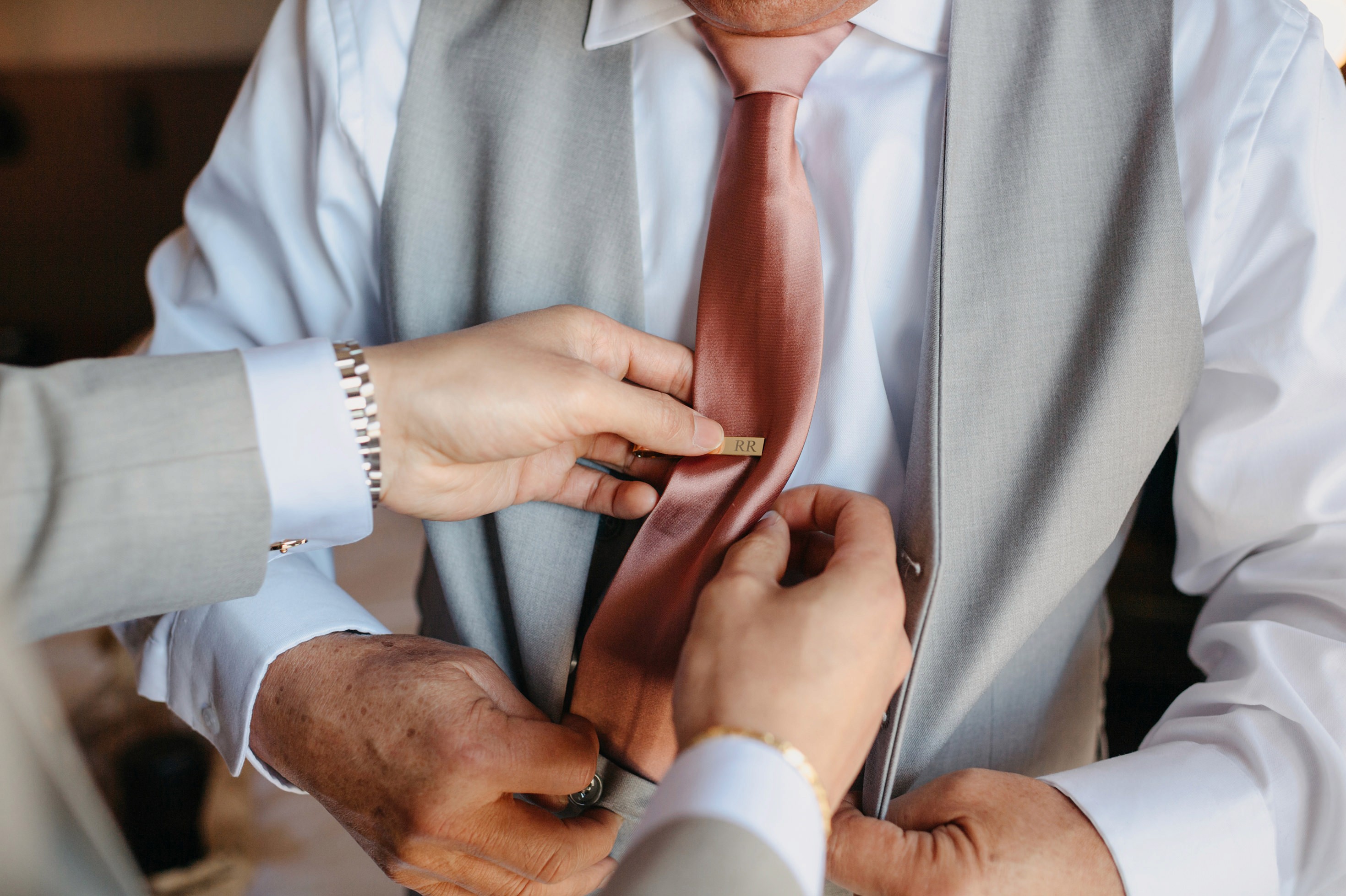 Flat lay wedding details with bouquet, rings, and sparkling bridal heels