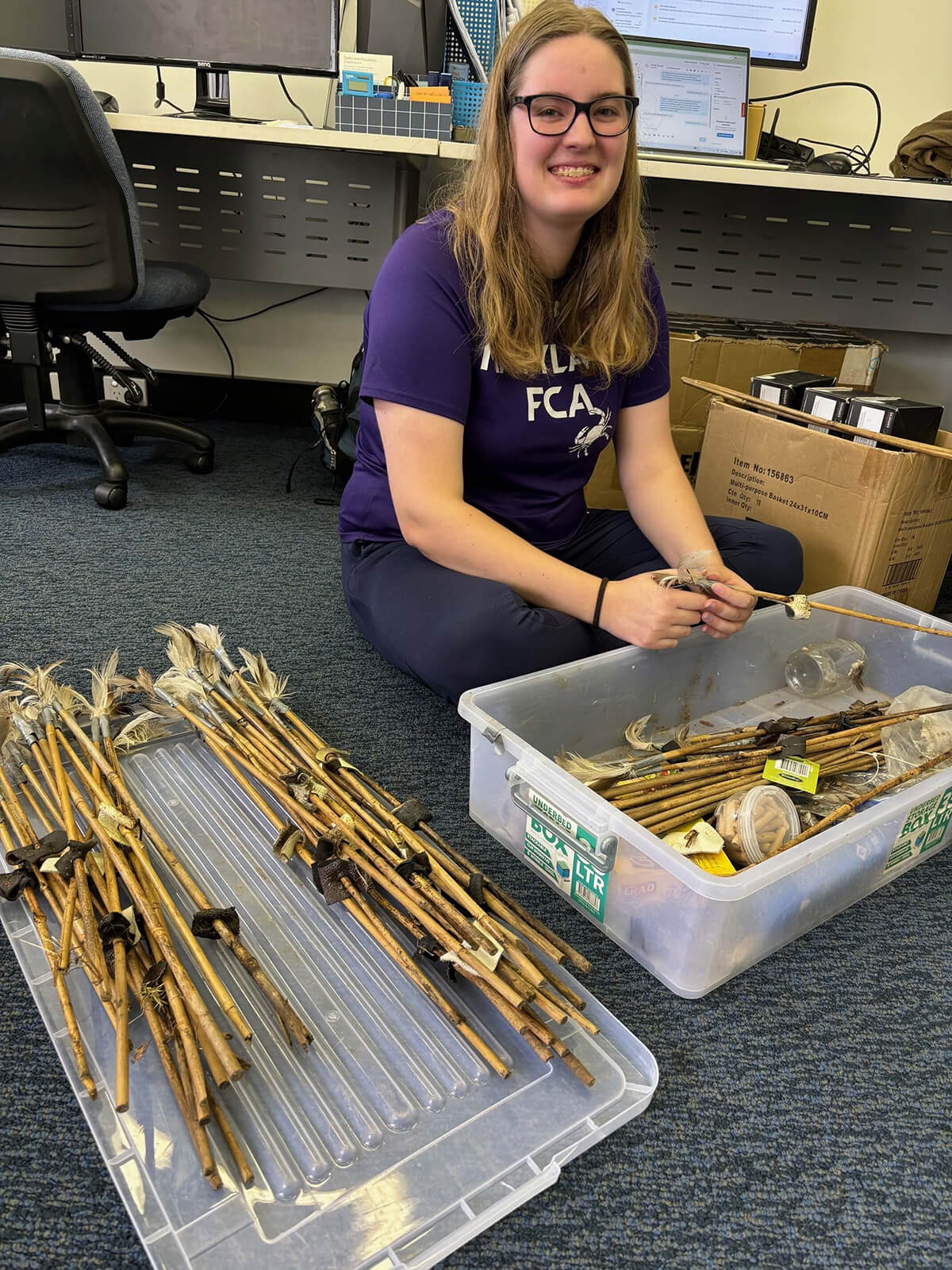 volunteer tying sticks into bundles