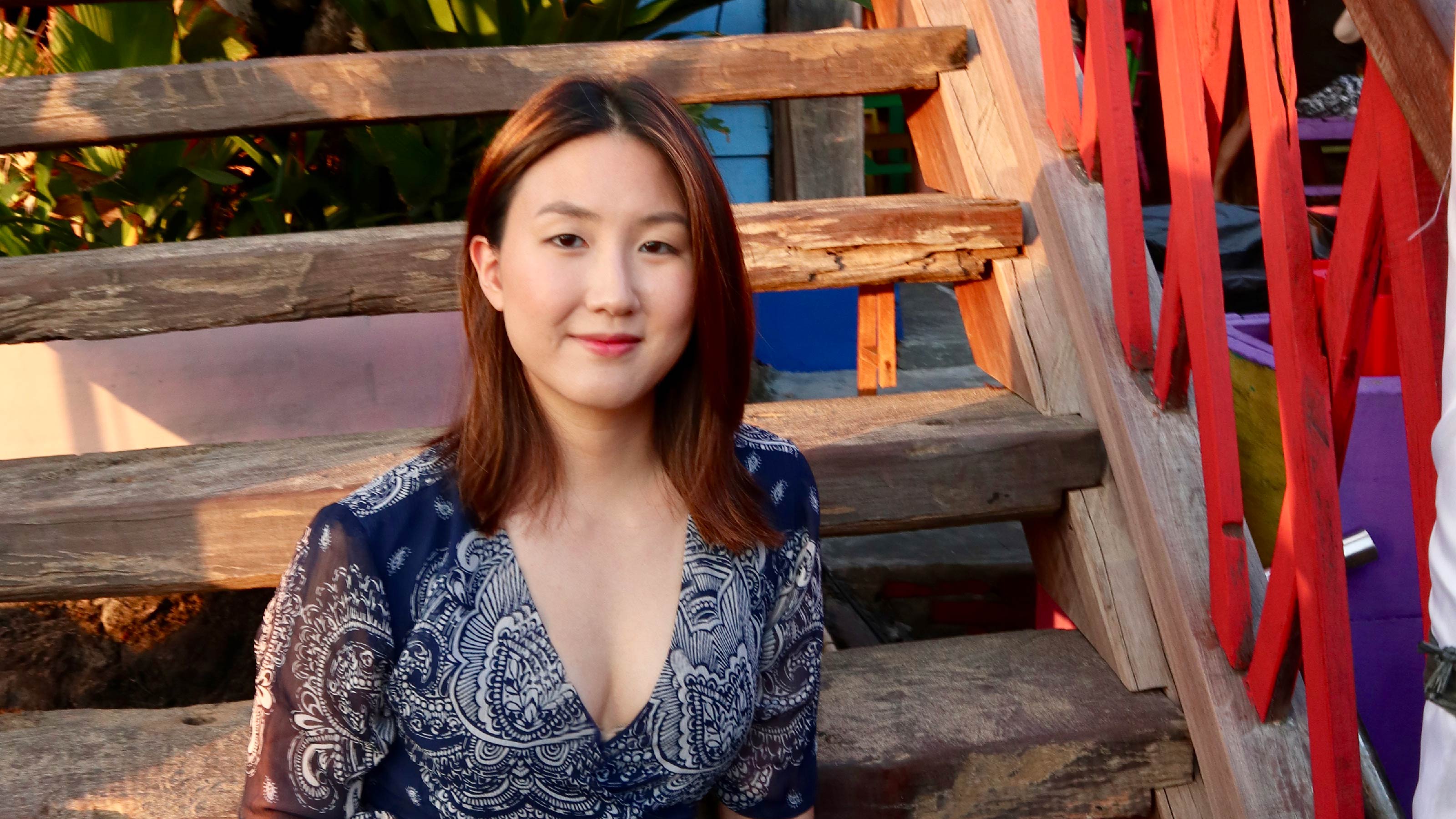 Catreen Yoon portrait by wooden staircase