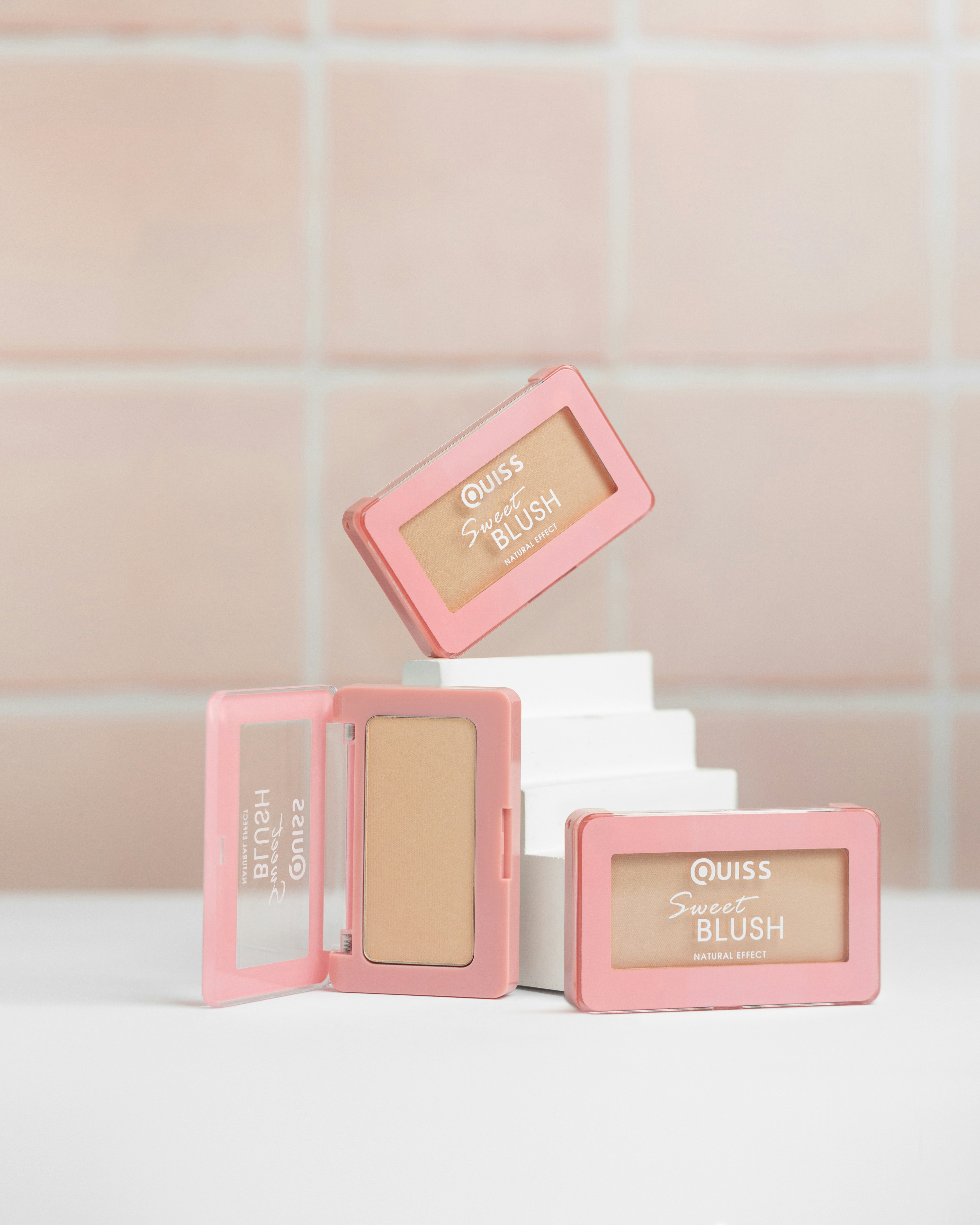 a group of pink and white bottles