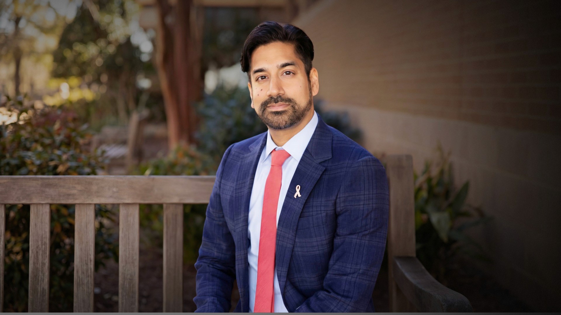 Photograph of Dr. Amar Rewari sitting on a bench.