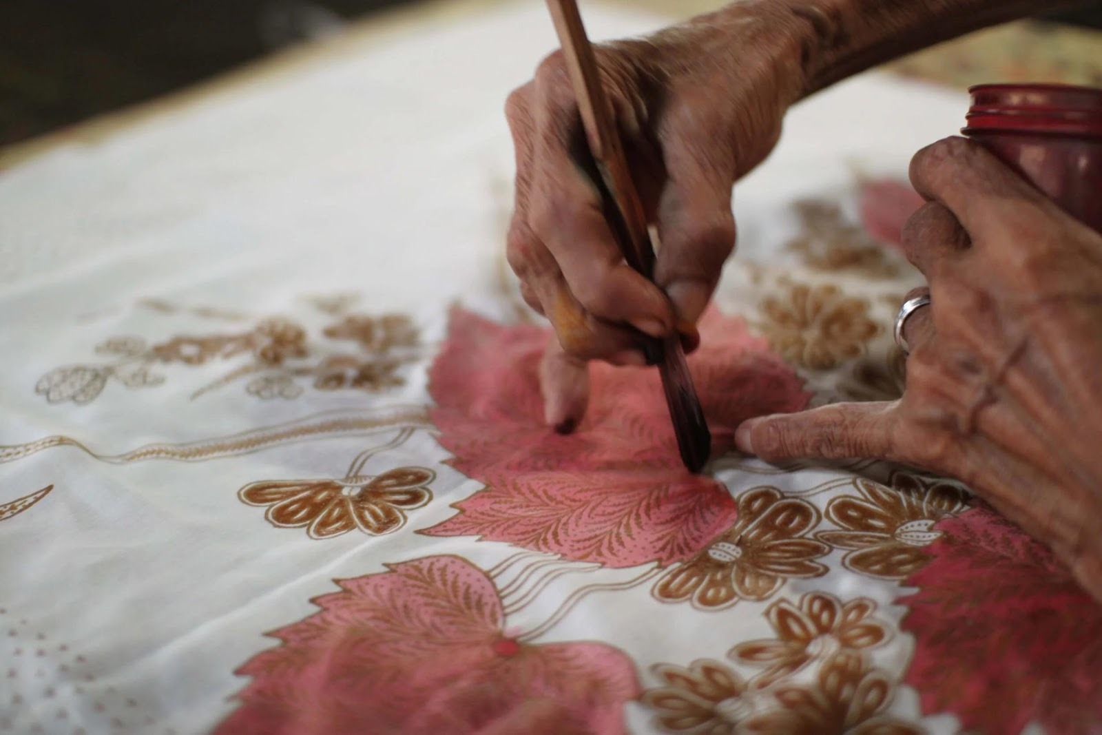 Batik artisans at work in Pekalongan, Indonesia — traditional wax-resist workshop.