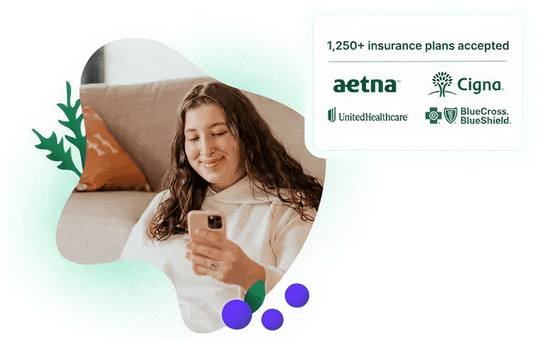 Woman smiling at her phone learning her nutrition therapy is covered by insurance