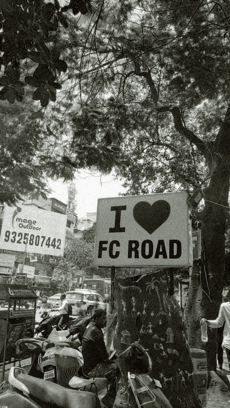 The timeless I LOVE FC ROAD banner displayed on FC Road outside Roopali.