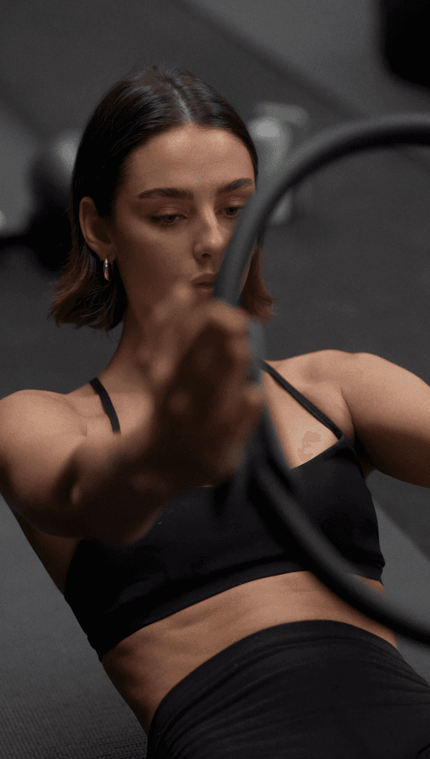 Woman in black outfit sitting on floor