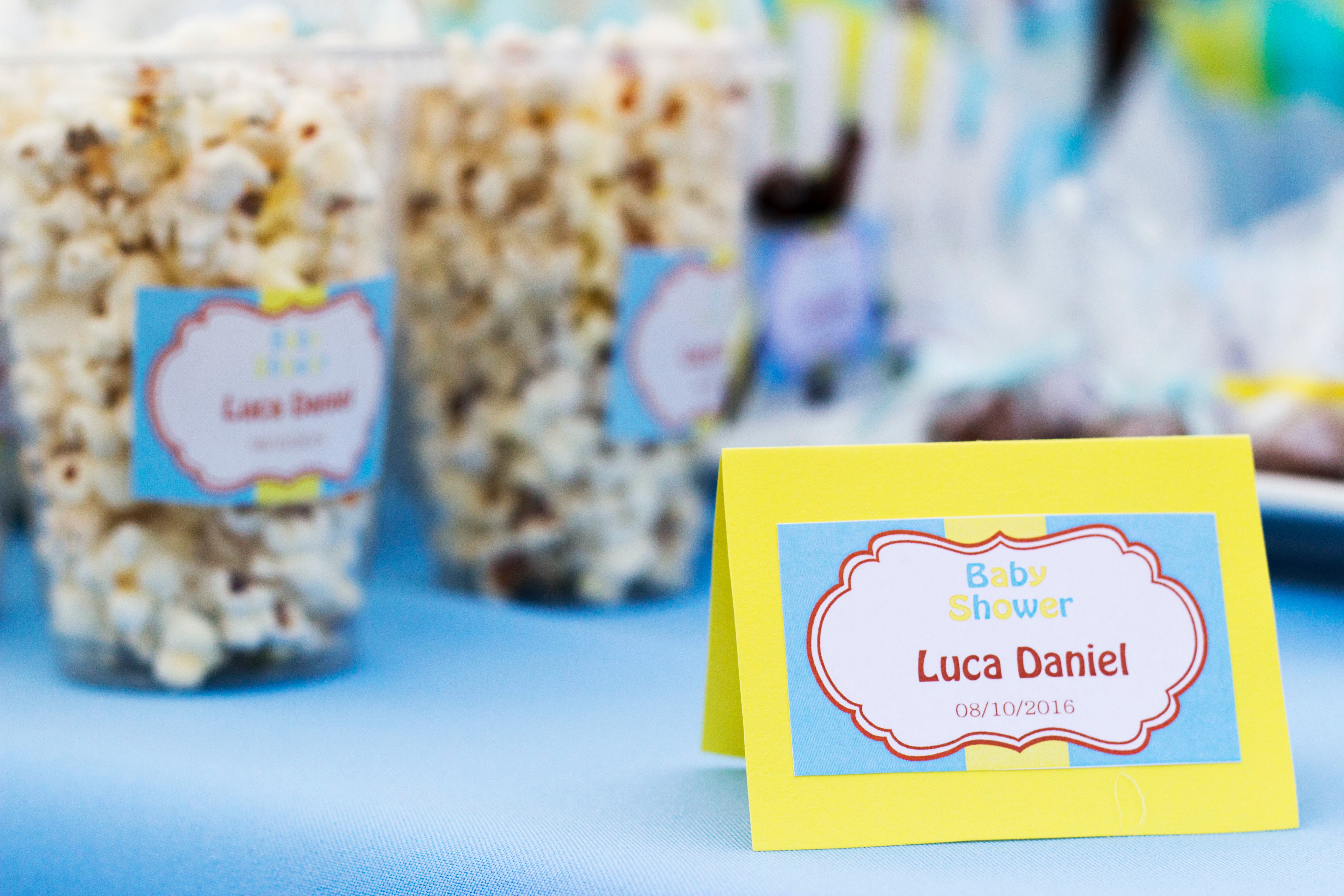 Baby shower invitation in front of snacks