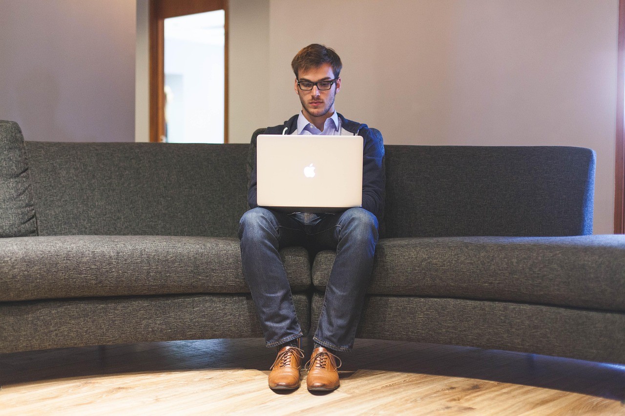 Coach focused on laptop while working remotely