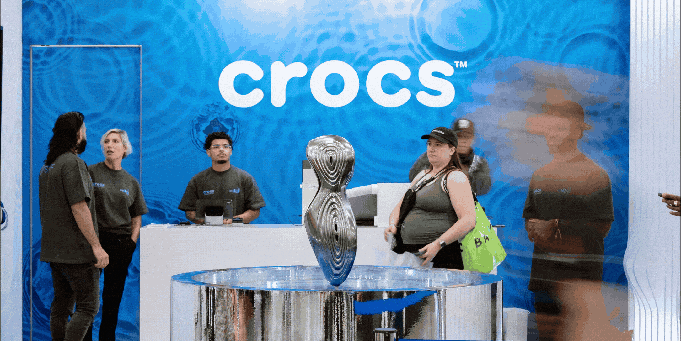 Top-down view of a bowl of white foaming cleanser with airy bubbles on a minimal surface.