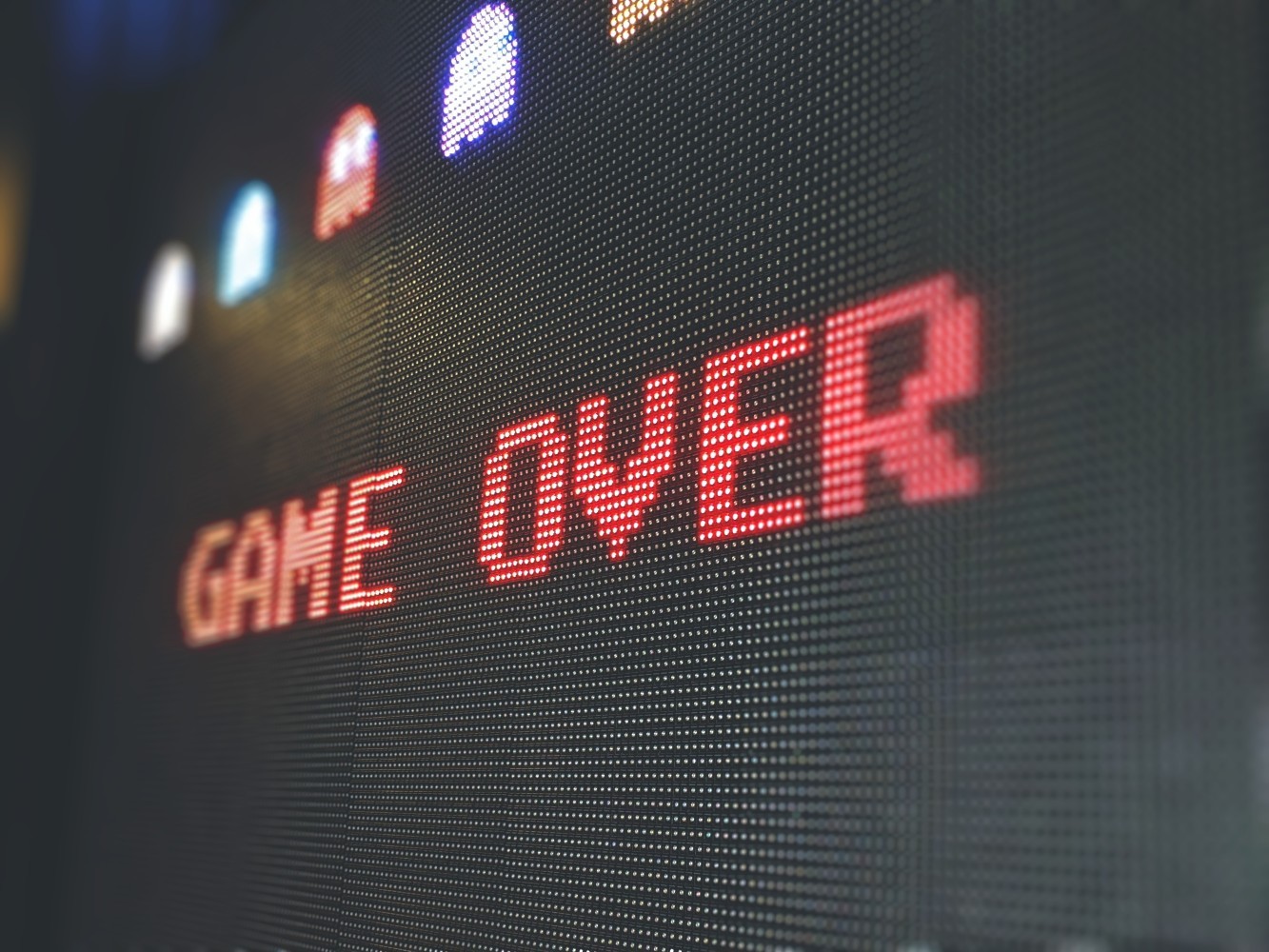 Photo of screen with "Game Over" written. Game characters above. Credit: Sigmund - Unsplash