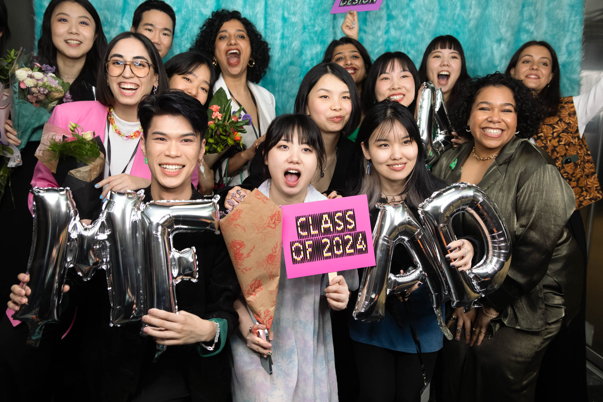 a group of students smiling for the camera in the SVA Theatre lobby after the Venture Forum