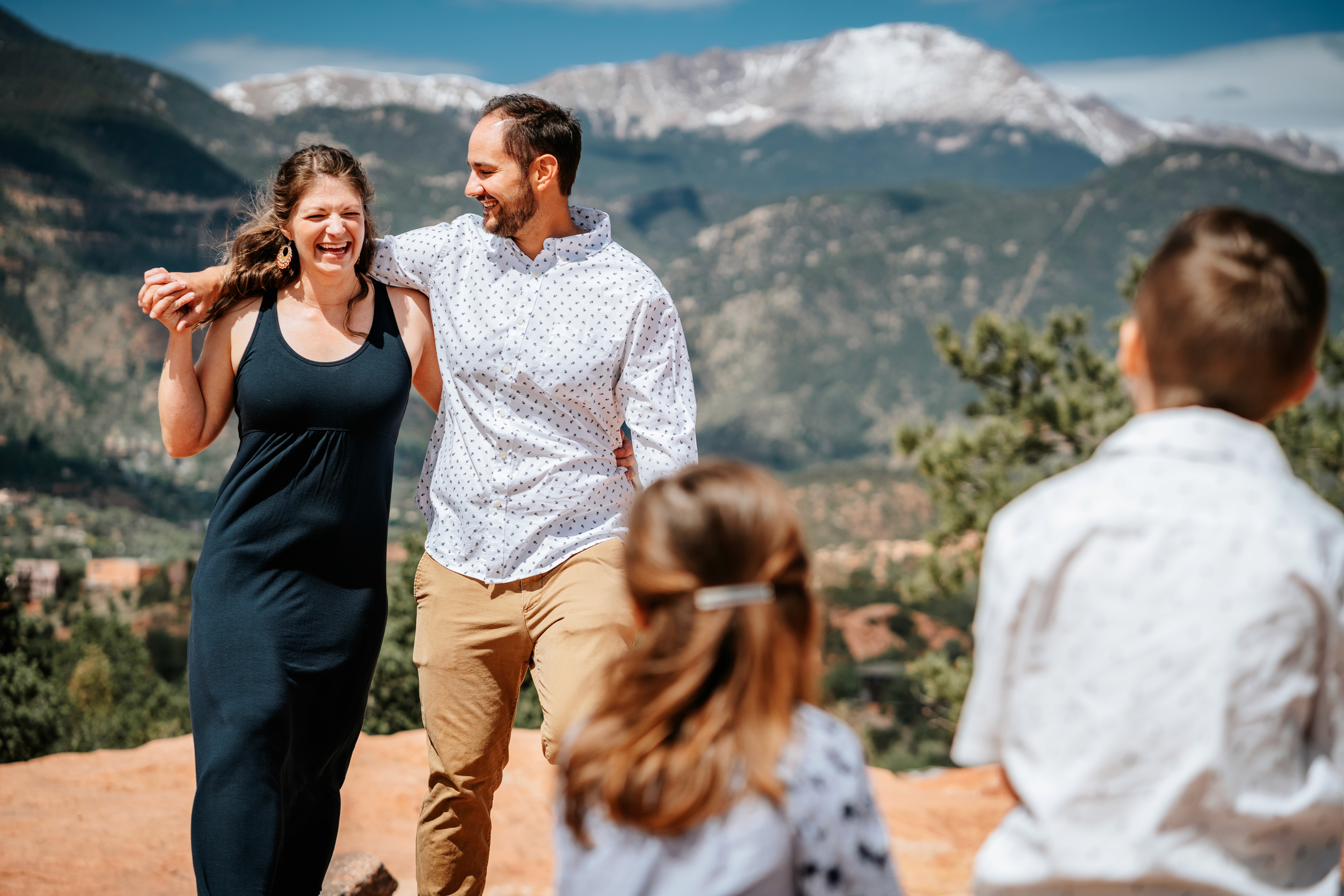 A couple in formal wedding attire embraces intimately in a vast.