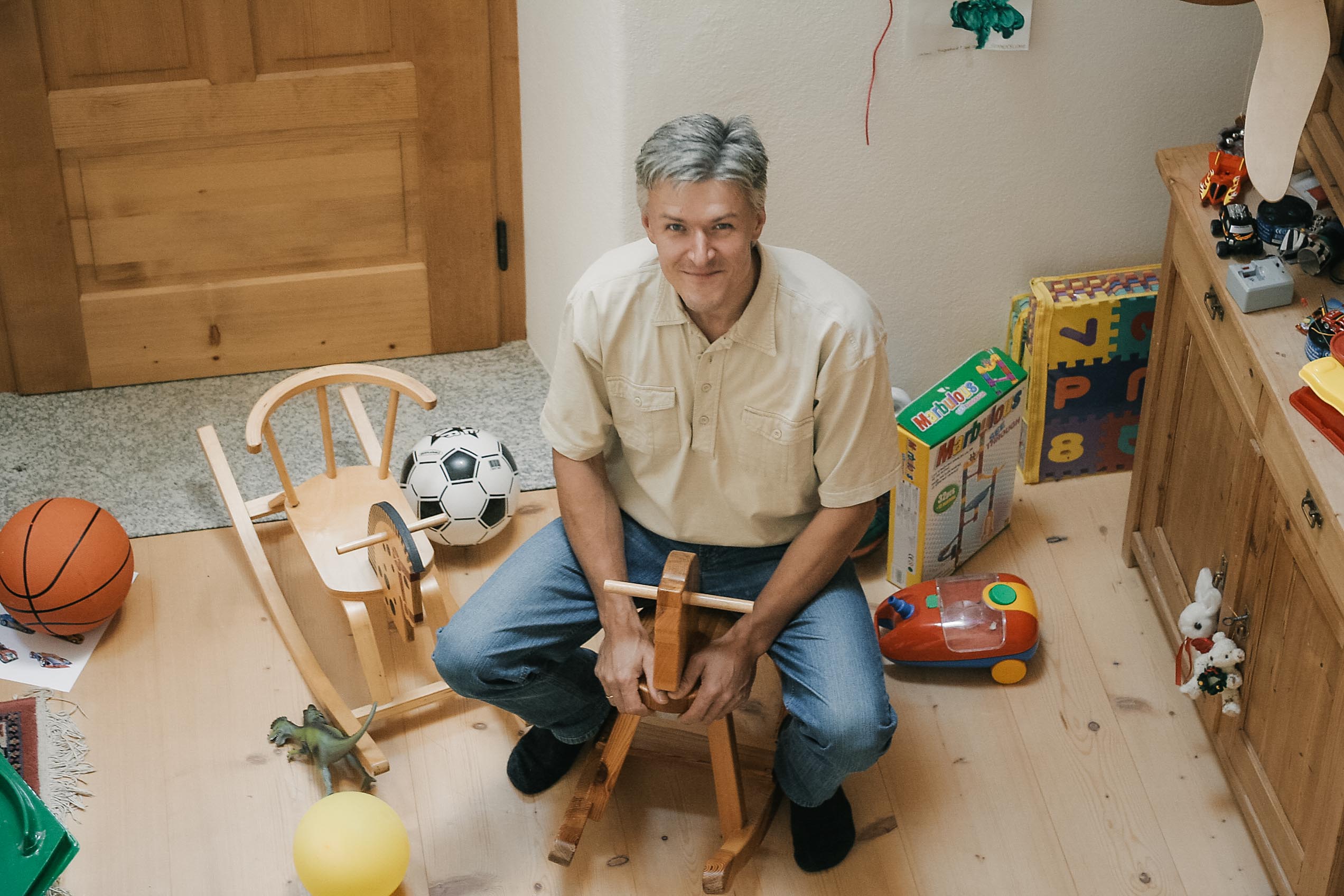 a person cutting a piece of wood with a knife
