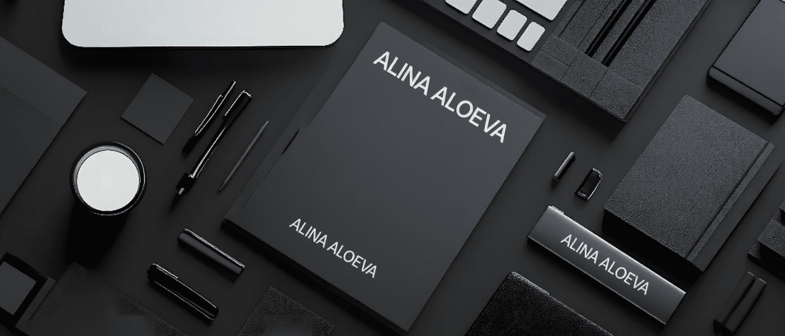 Black and white flat lay of dark branding materials with a "LUNA ALOE" notebook.