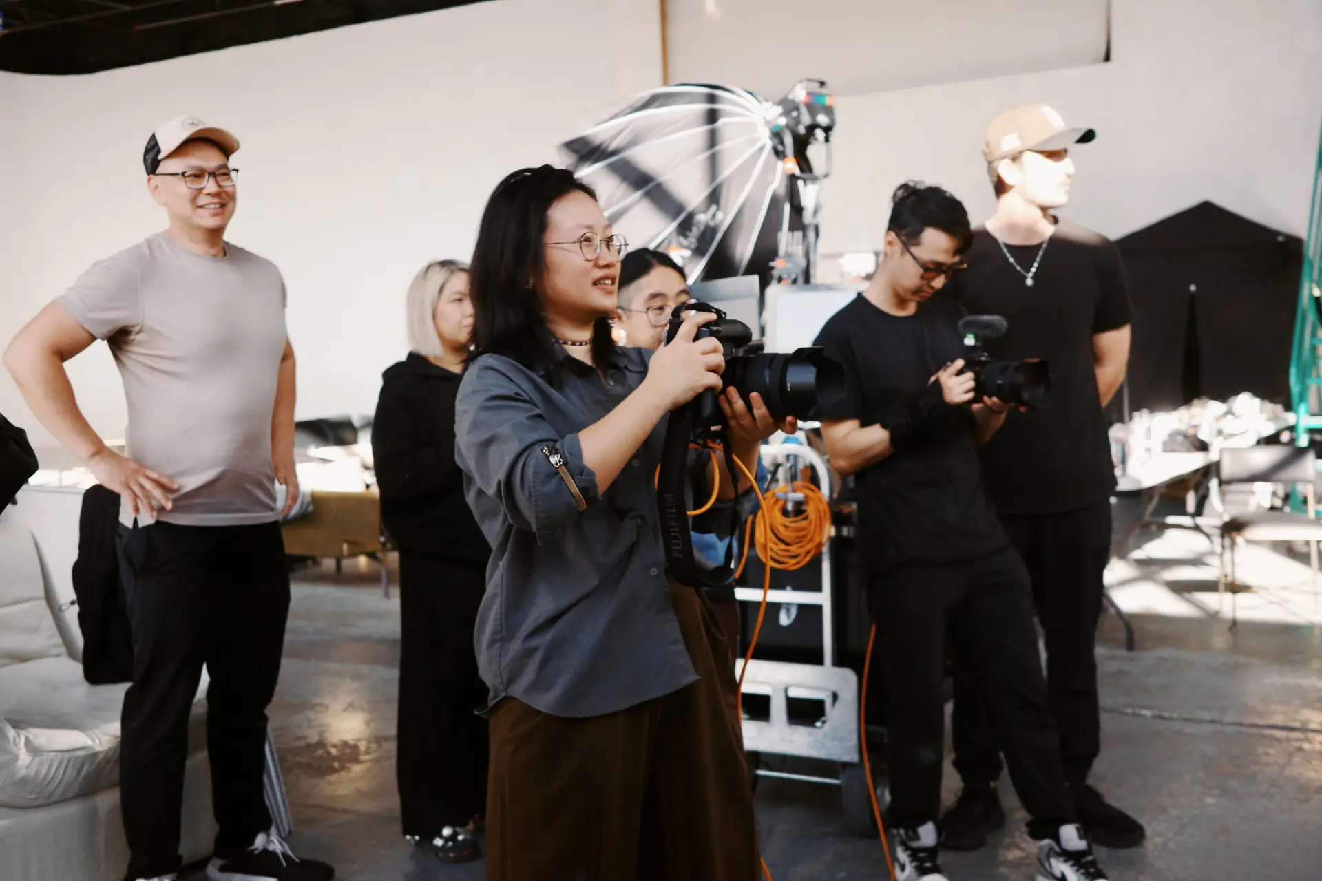 Three people sitting on a couch in a room looking at mobile devices
