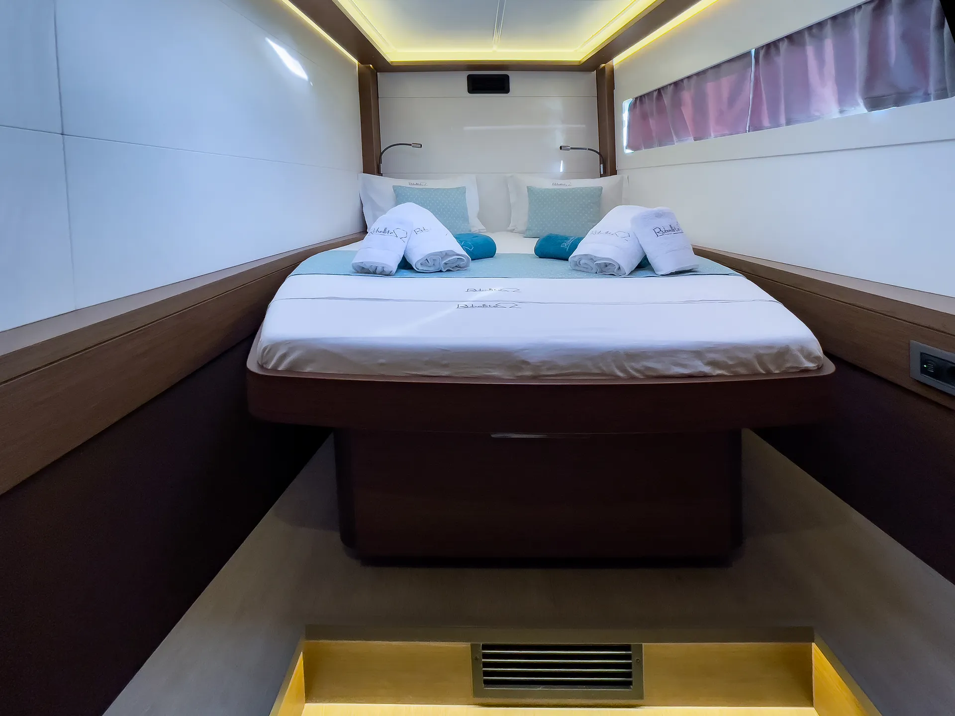 White Rock 36 speedboat with captain at helm cruising calm blue waters near Paros coastline with hills in background.