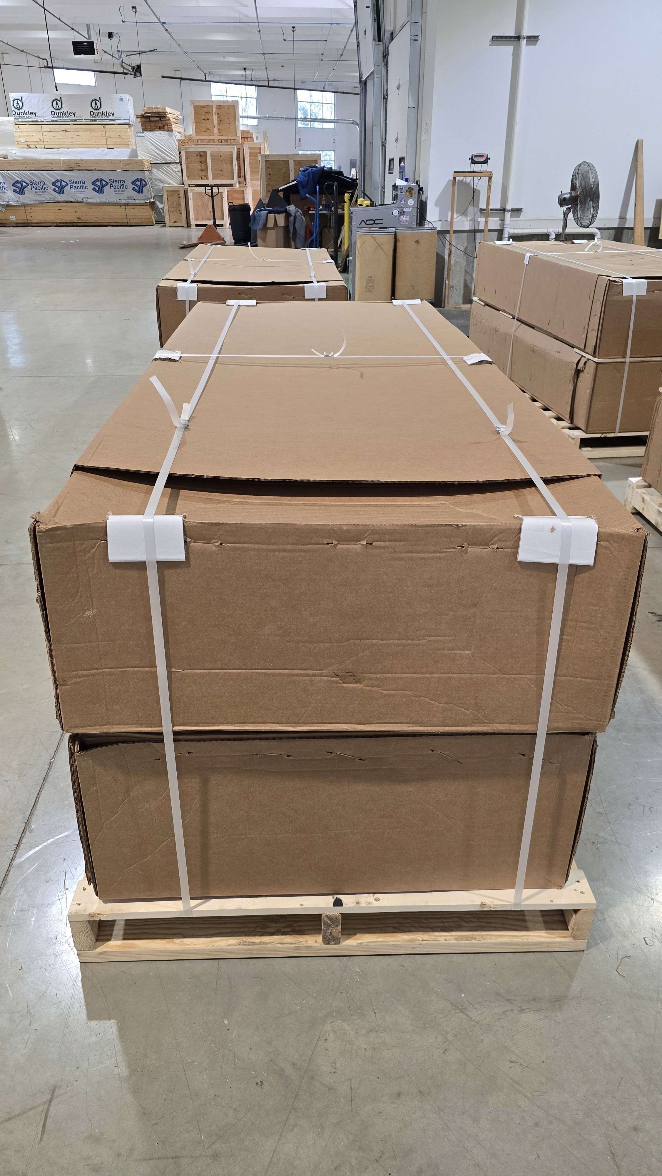 Close-up of a dark green leaf showing its textured surface and central vein against a muted background.