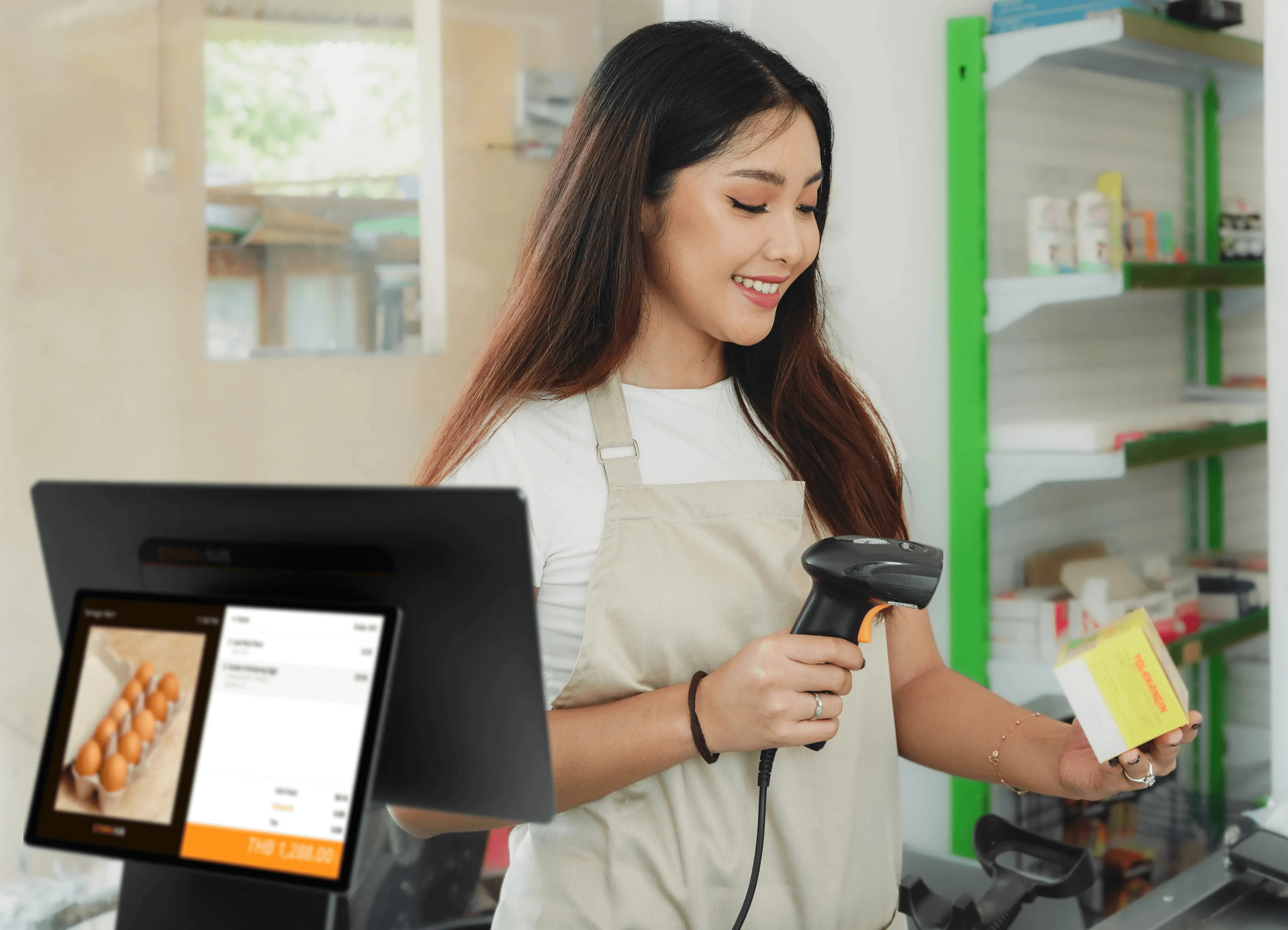 Thai retail staff using the StoreHub cloud POS system with barcode scanner for in-store checkout and payment processing.
